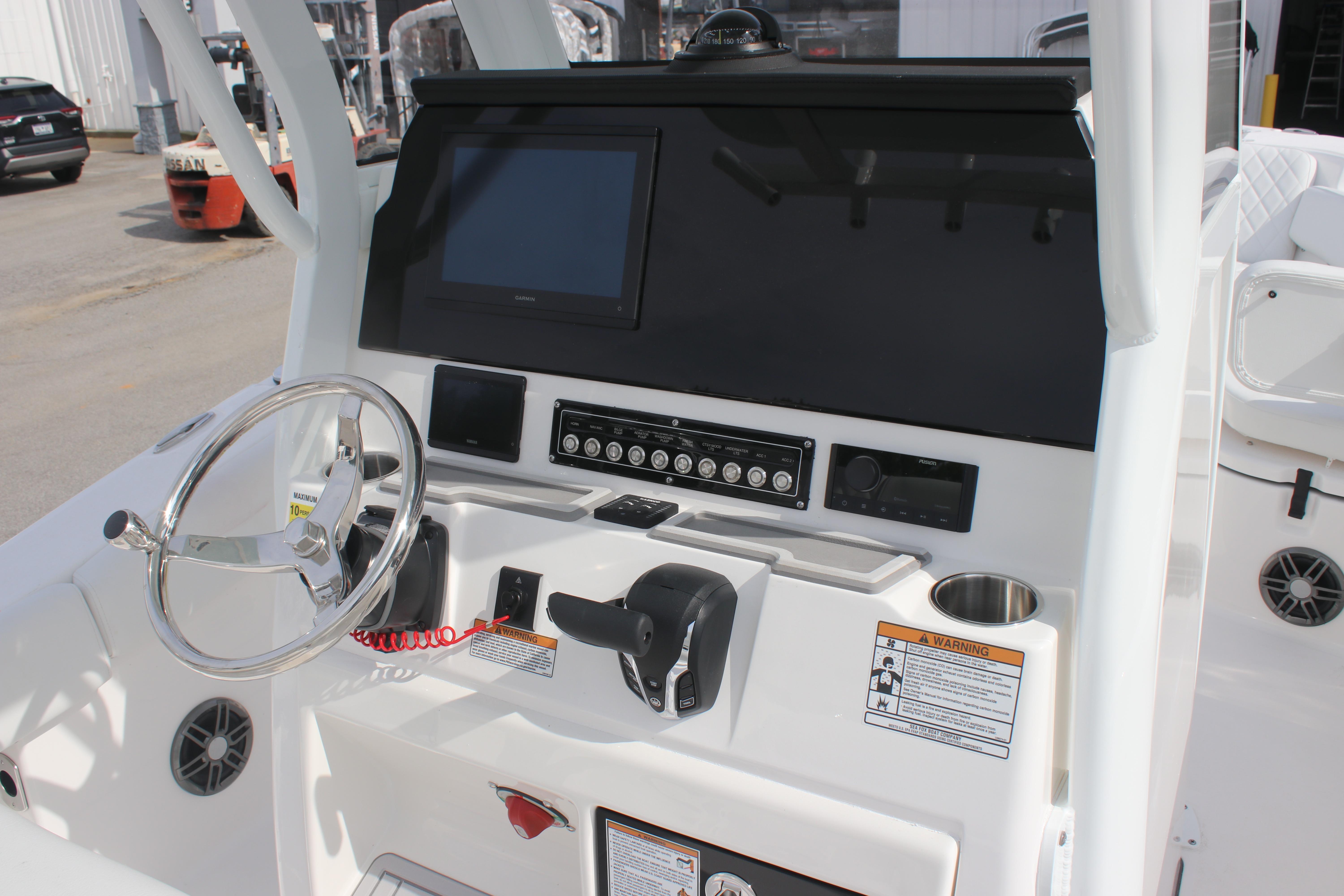 2026 Sea Fox 248 Commander boat dashboard with steering wheel and control panel.