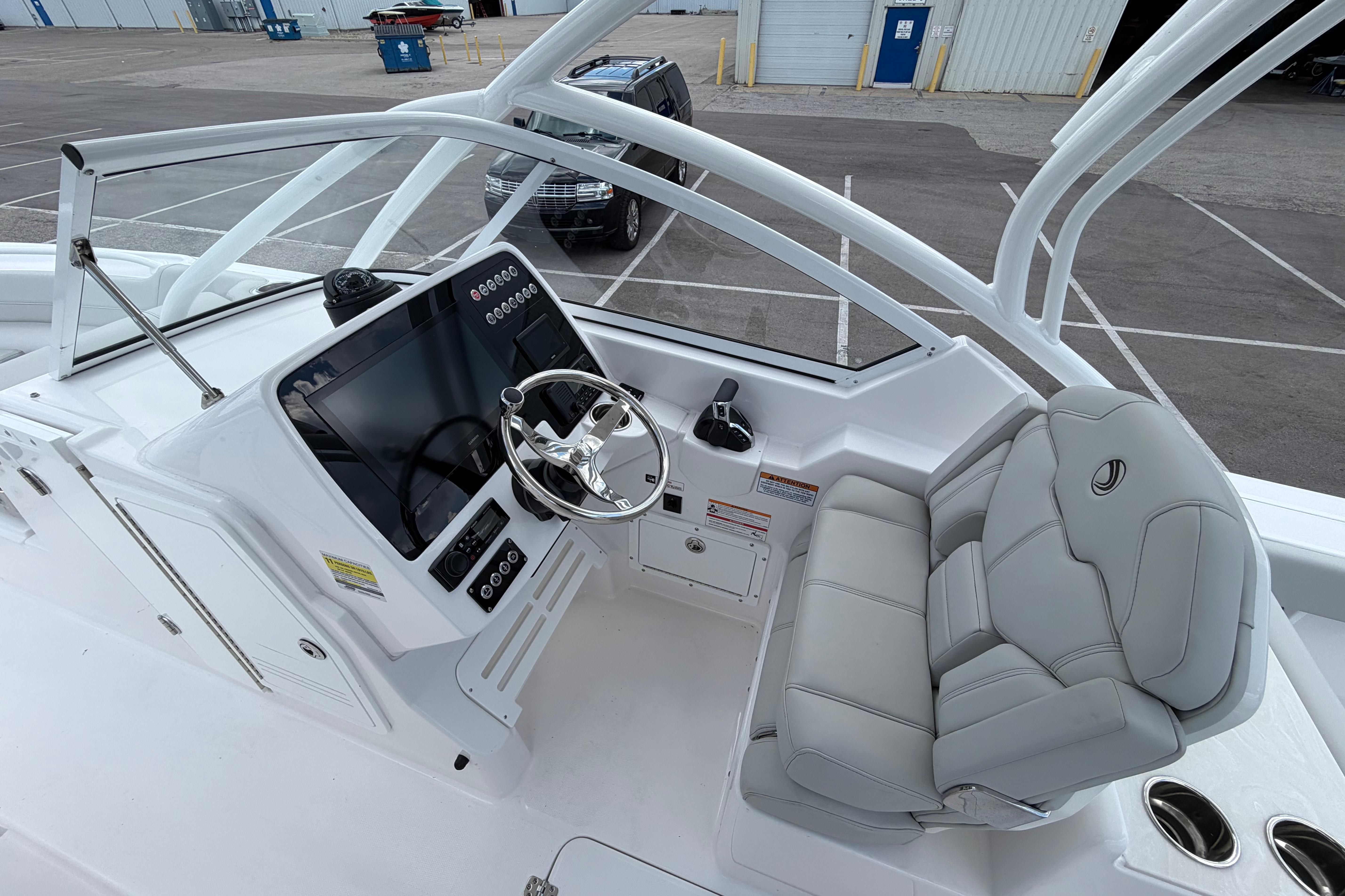 2026 Edgewater 248CX Crossover boat cockpit with modern steering and comfortable seating.