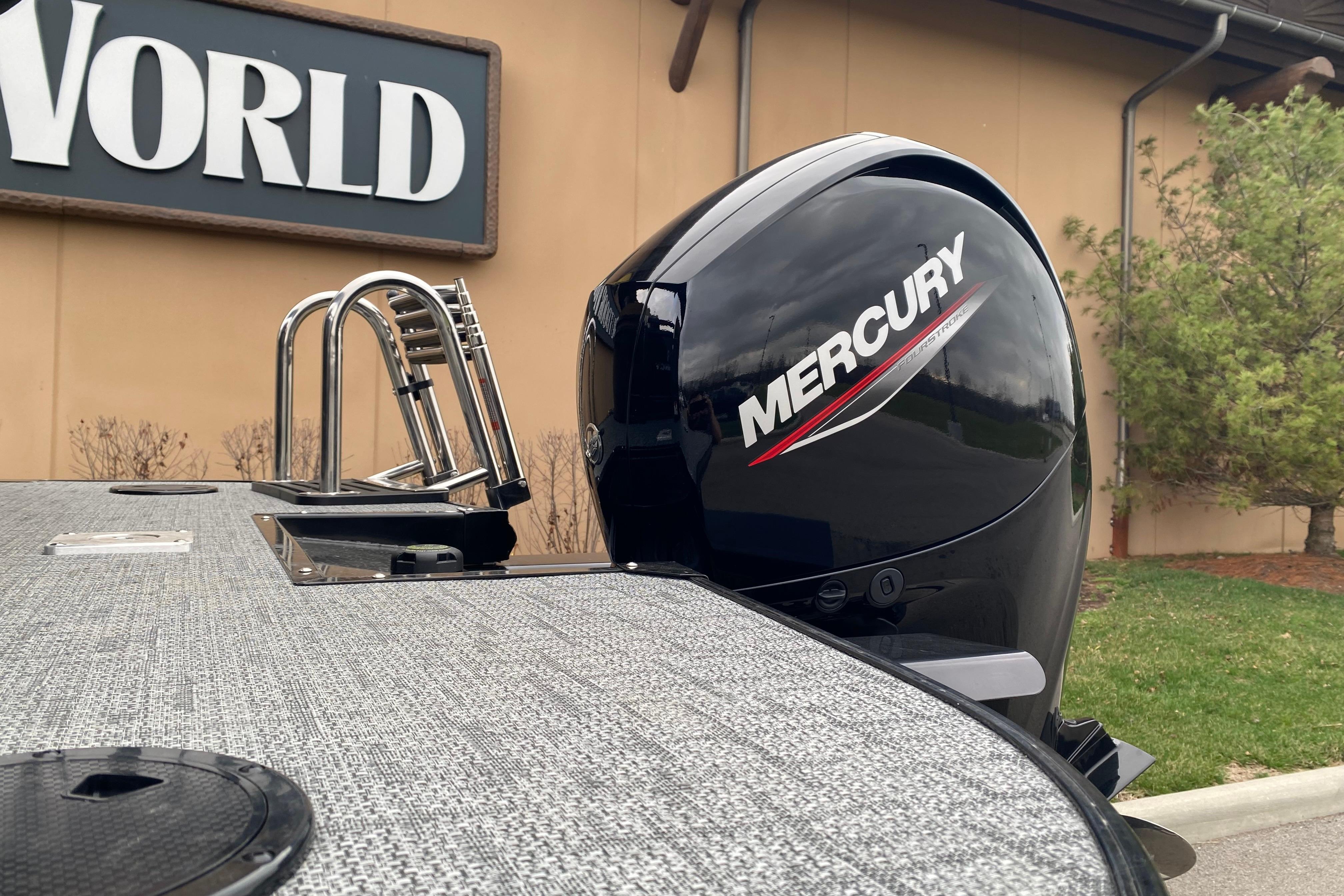 2026 Regency 230 DL boat with Mercury outboard motor, displayed outdoors.