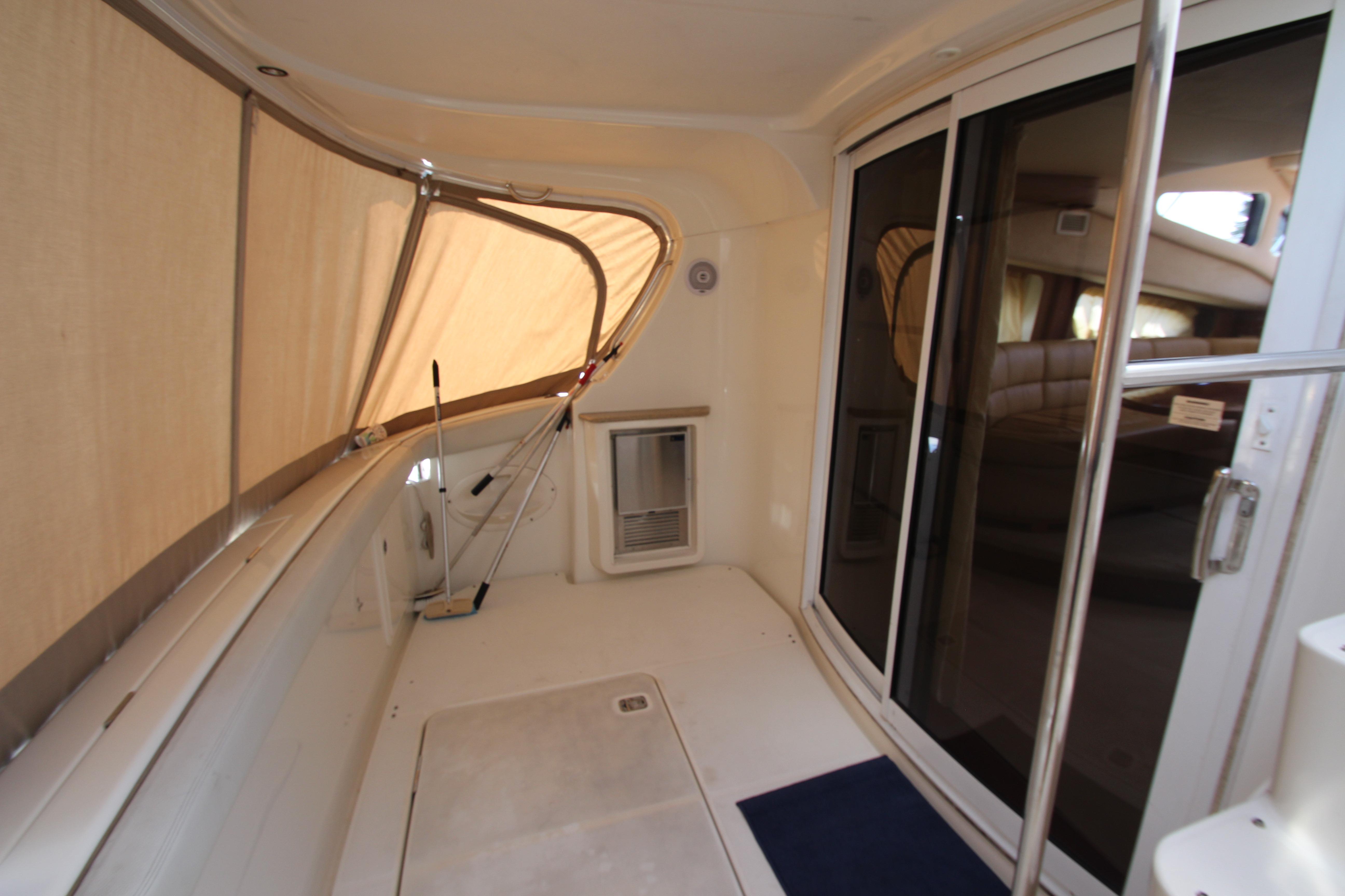 2006 Silverton 38 Sport Bridge interior with sliding glass doors and beige seating area.