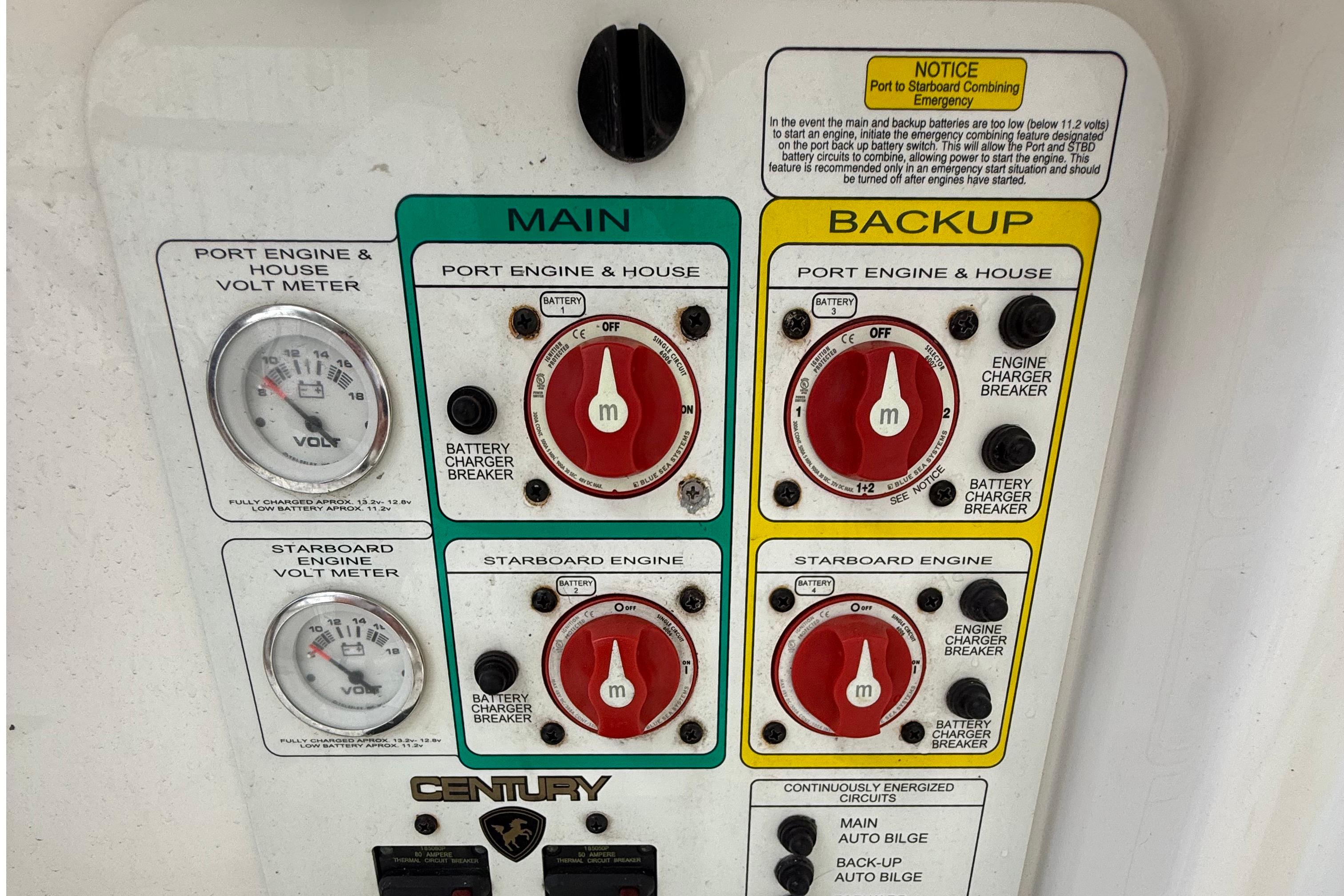 Control panel of a 2008 Century 2901 Center Console boat with volt meters and battery switches.