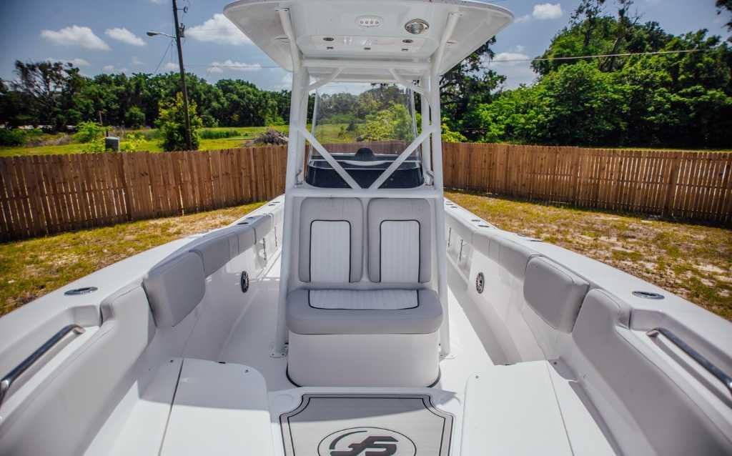 2021 Sea Fox 248 Commander boat interior with seating and console, outdoors.