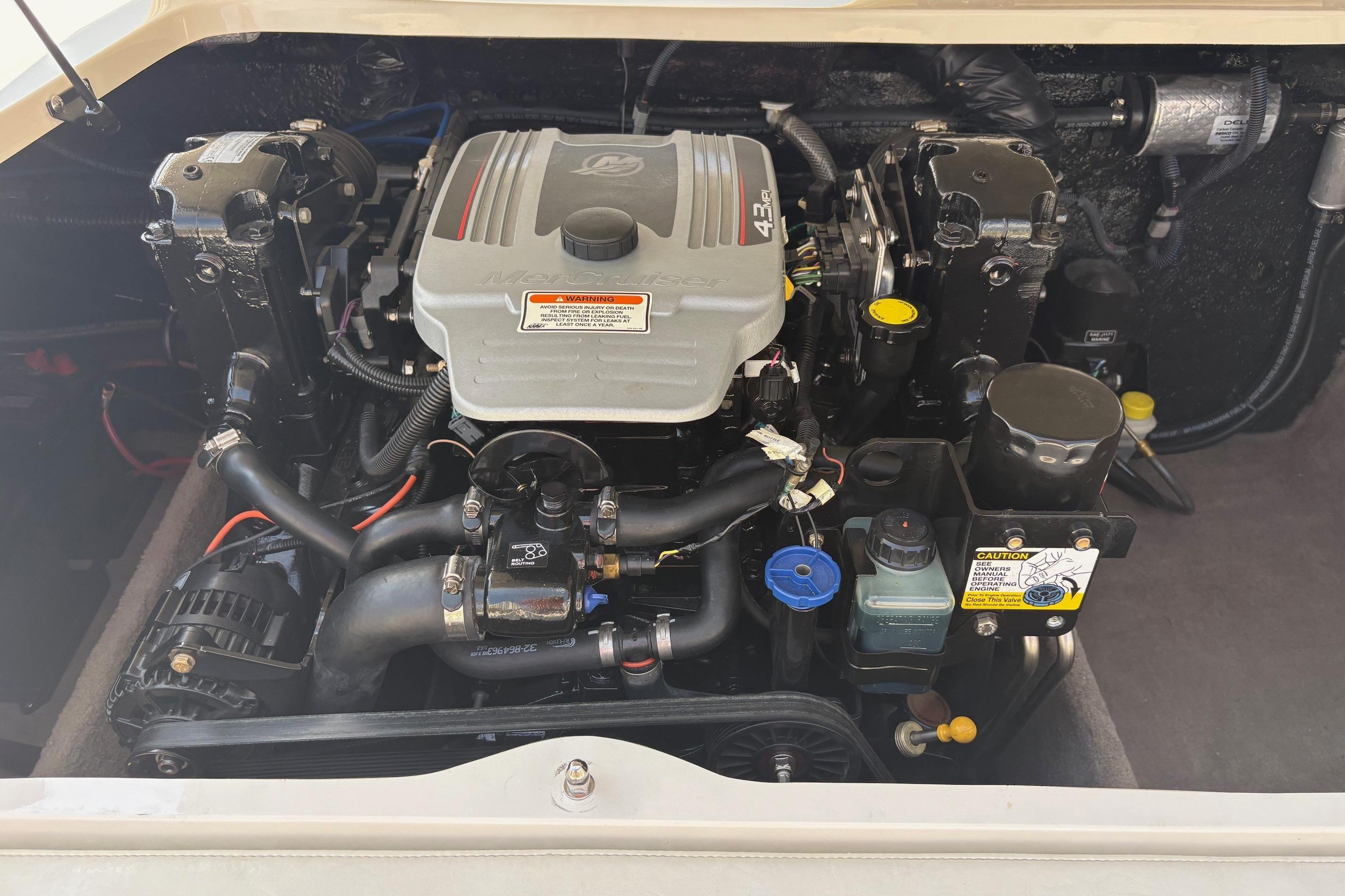 Engine compartment of a 2013 Stingray 198 LX boat, showcasing detailed components and layout.