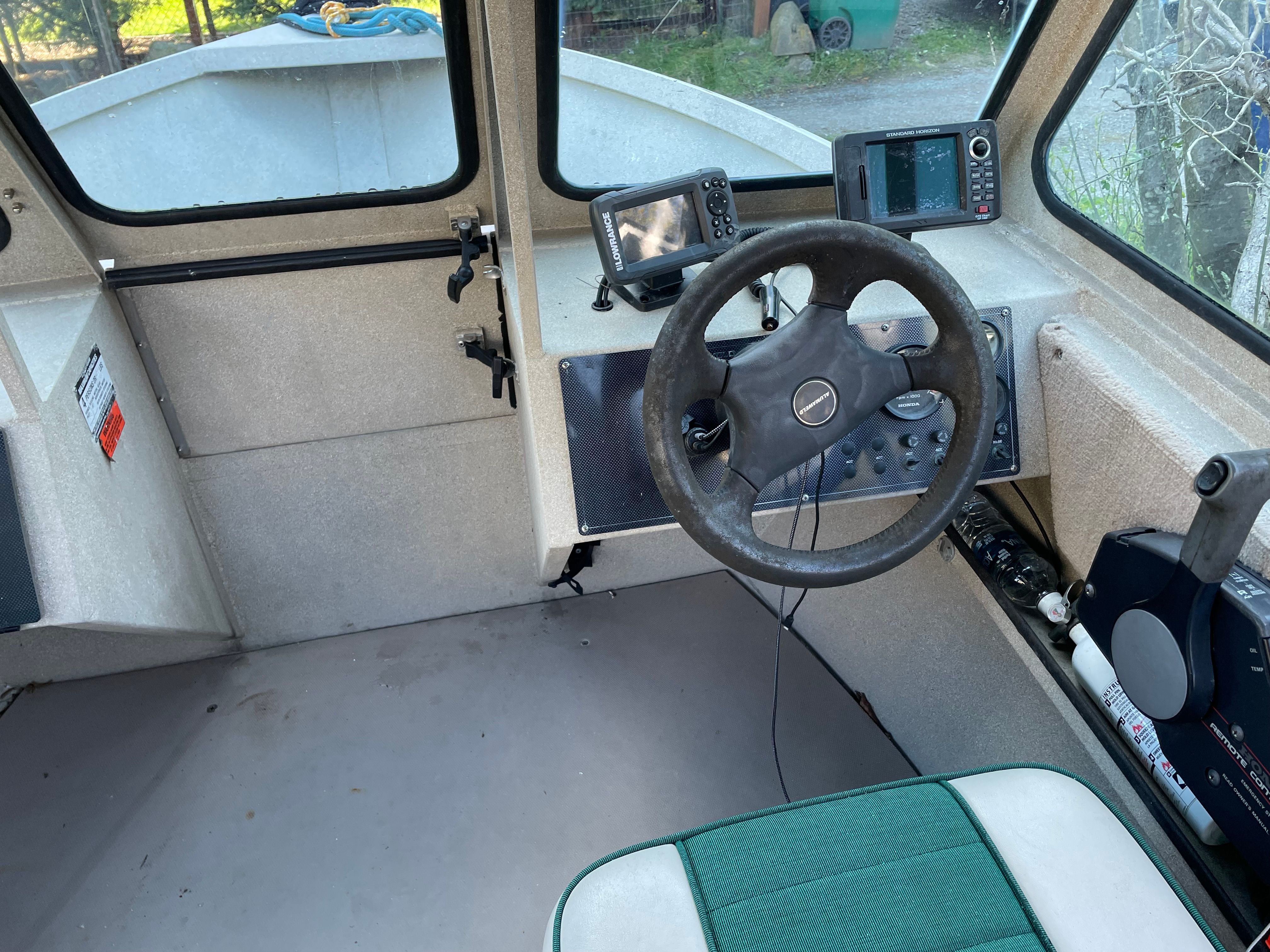 Interior of a 2001 Alumaweld Stryker boat with steering wheel and navigation equipment.
