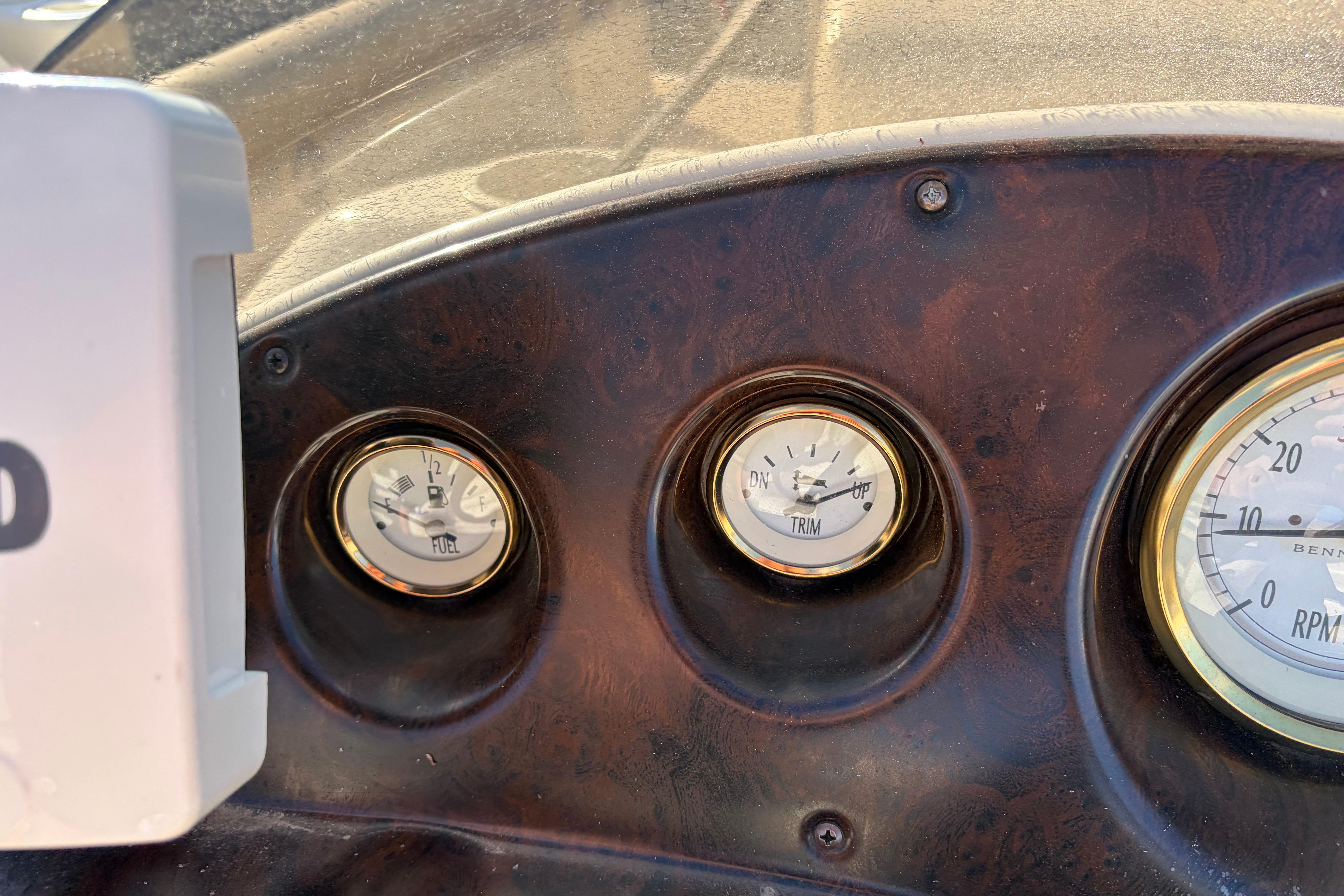 Dashboard gauges of a 2003 Bennington 2250RSi boat, showing fuel, trim, and RPM levels.