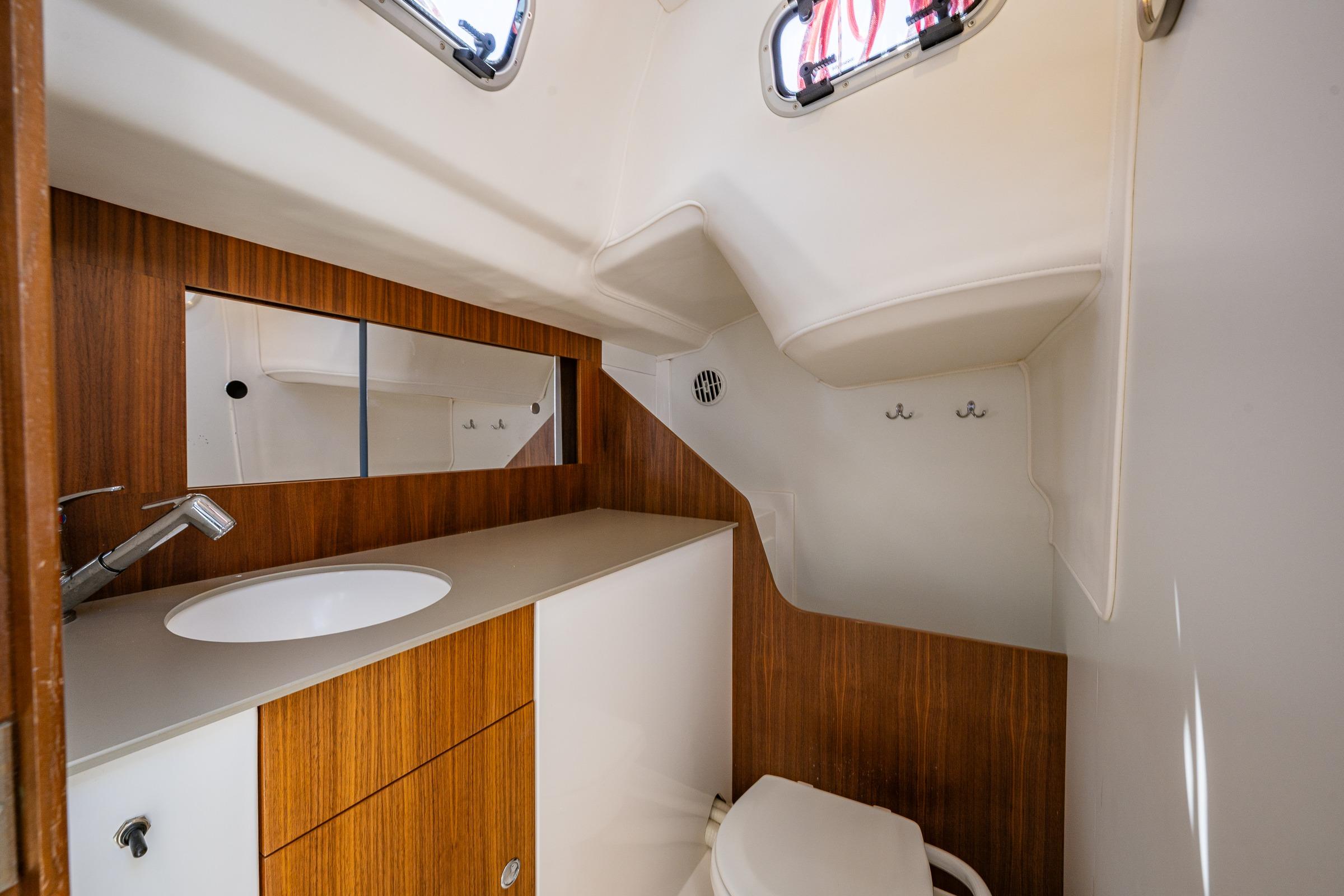 2018 J Boats J/97E yacht bathroom with wooden cabinetry and modern fixtures.