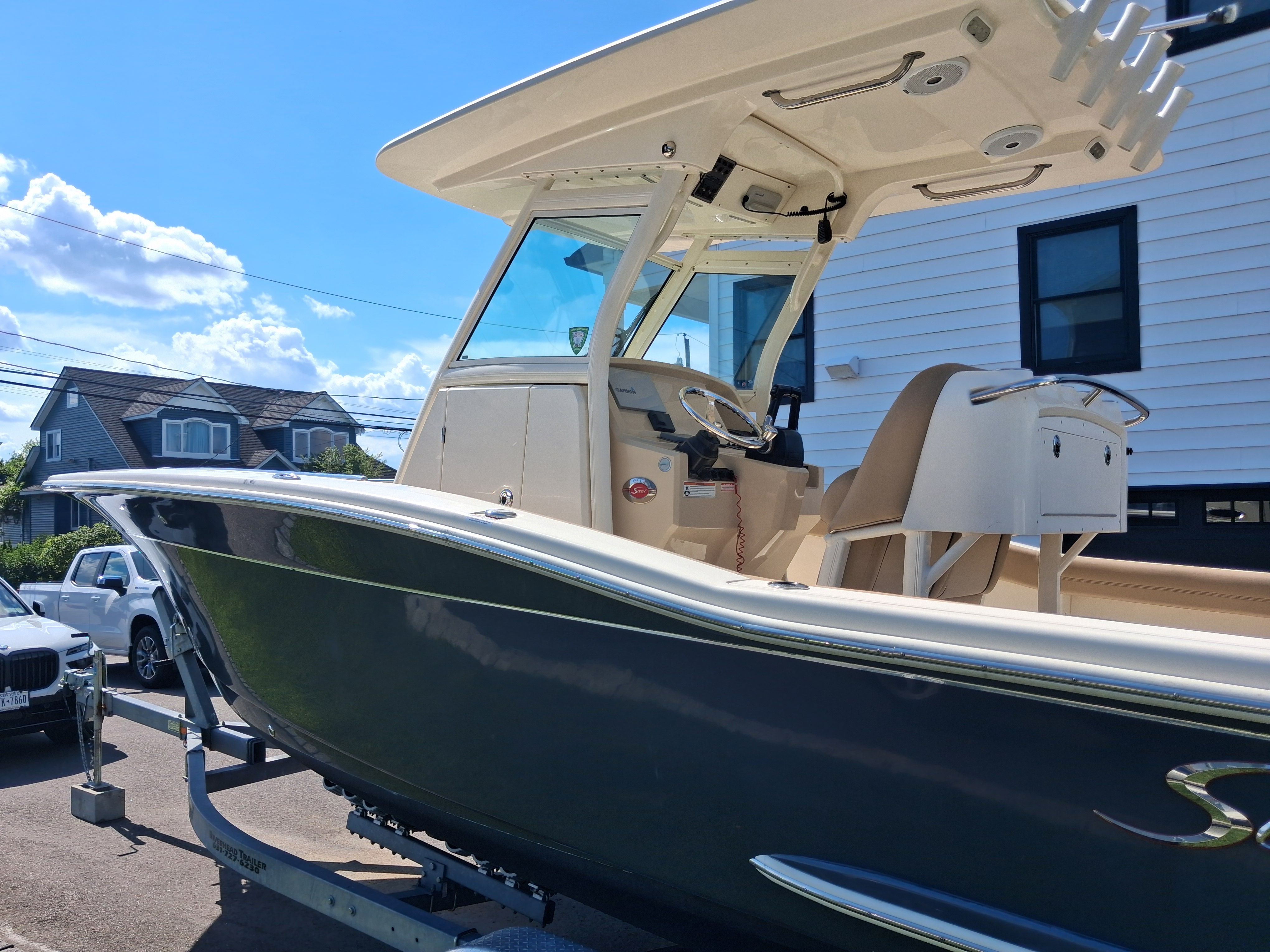 2018 Scout 255LXF boat on trailer, sunny day.