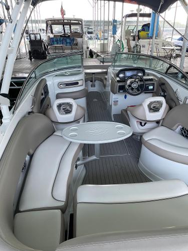 2019 Crownline E255 boat interior with seating, table, and steering wheel.