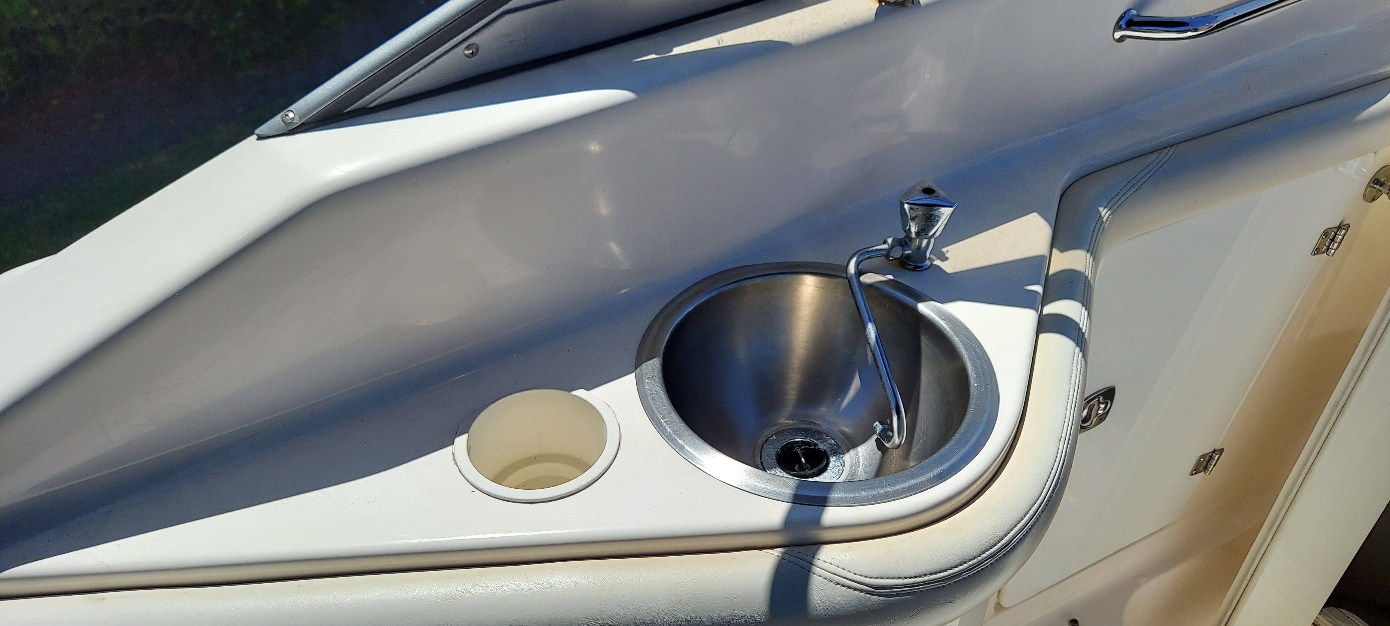 2004 Regal Commodore 2465 with built-in sink and cup holder.