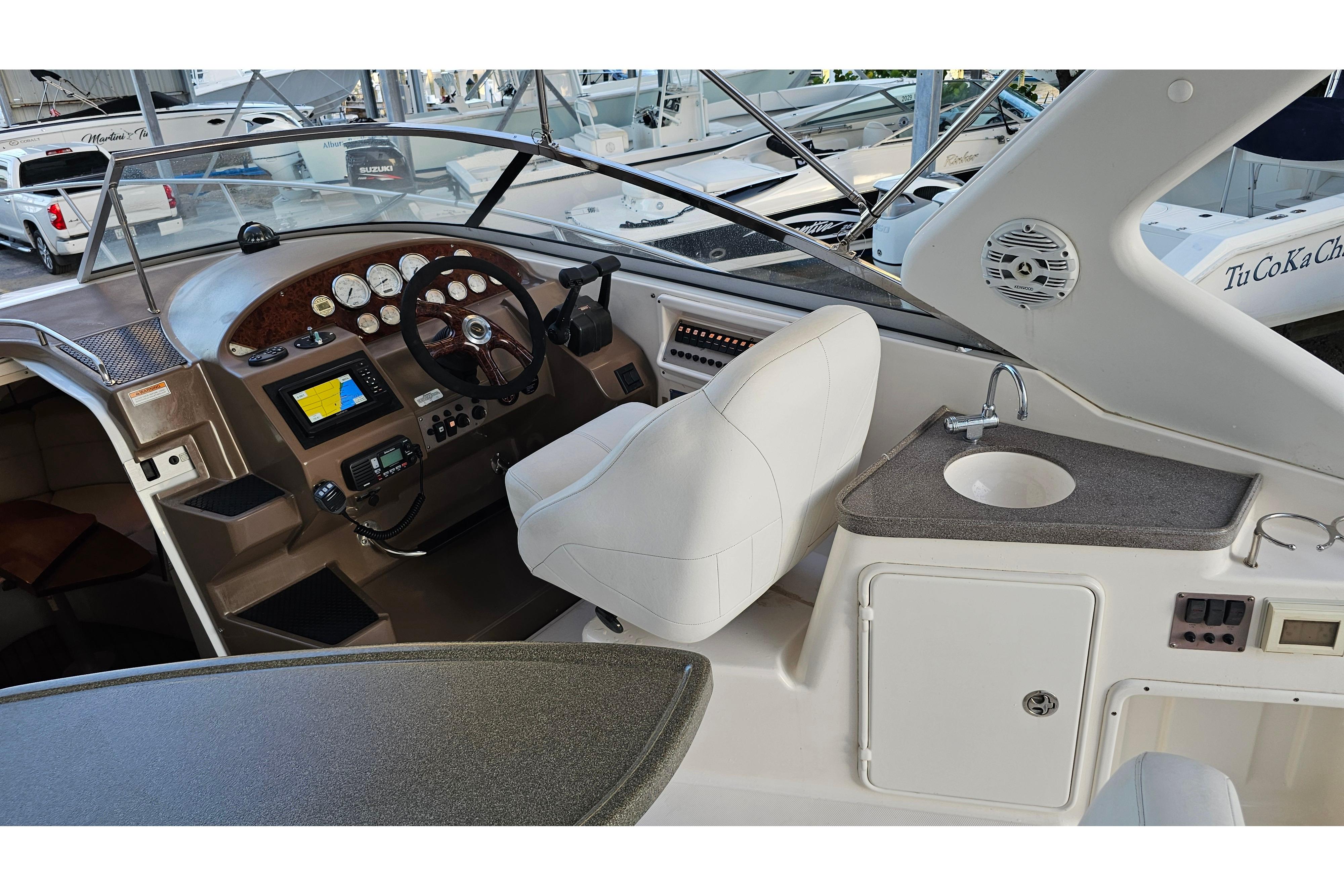 2005 Regal 3060 Window Express boat interior with helm, sink, and seating area.