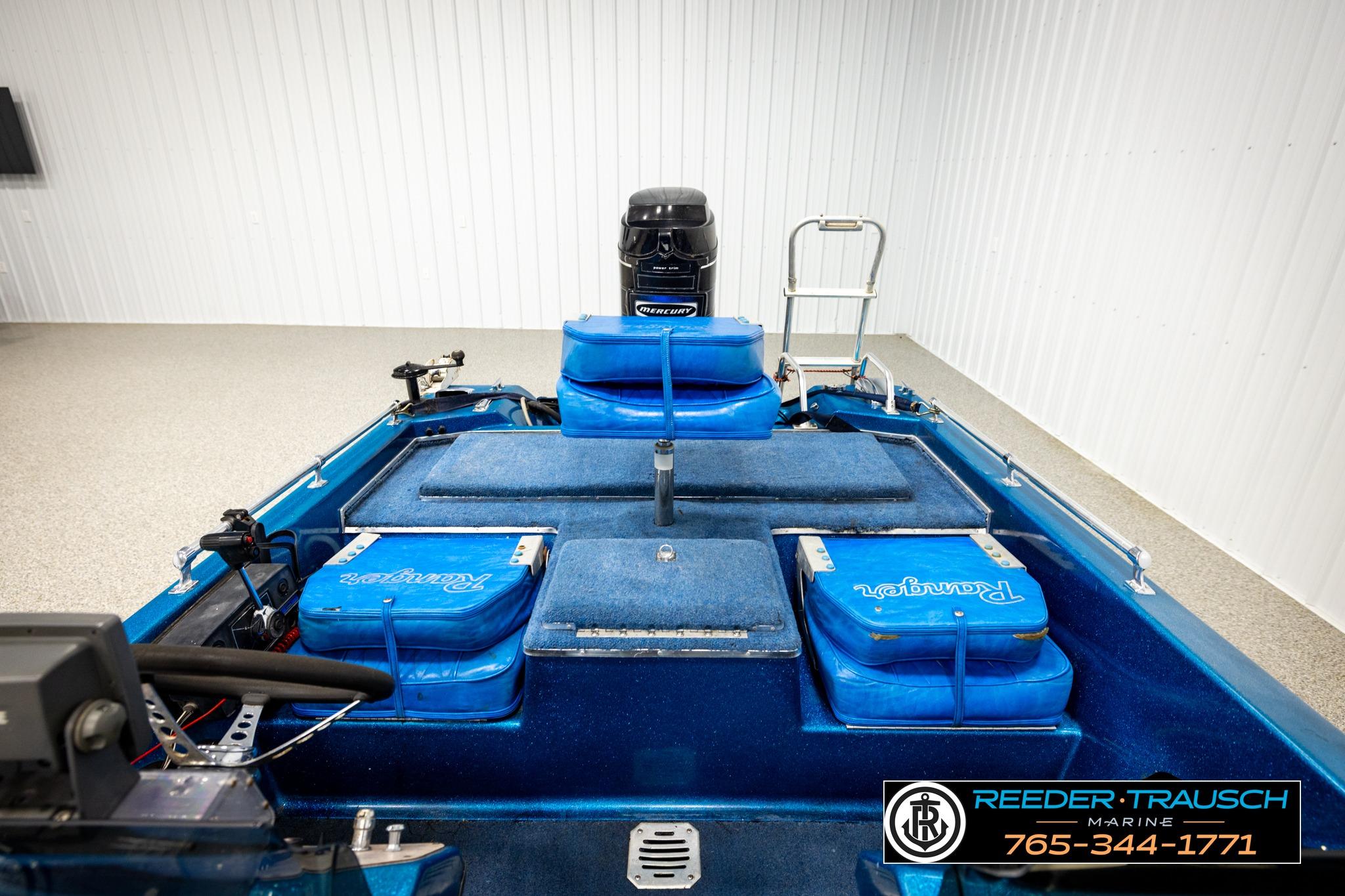 1980 Ranger 175 VS boat interior with blue seating and Mercury outboard motor.