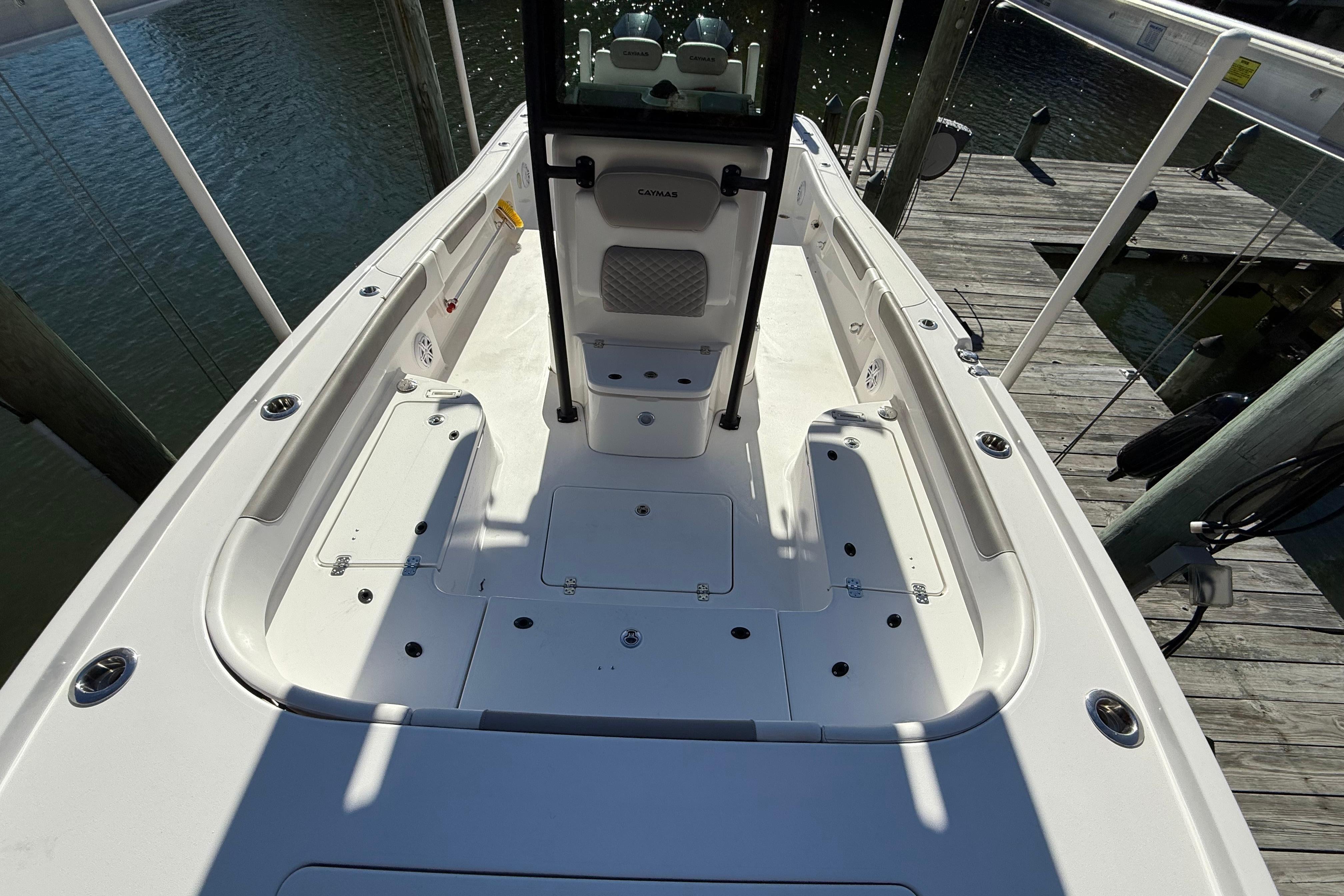 2023 Caymas 281 HB boat deck view, docked by the water.