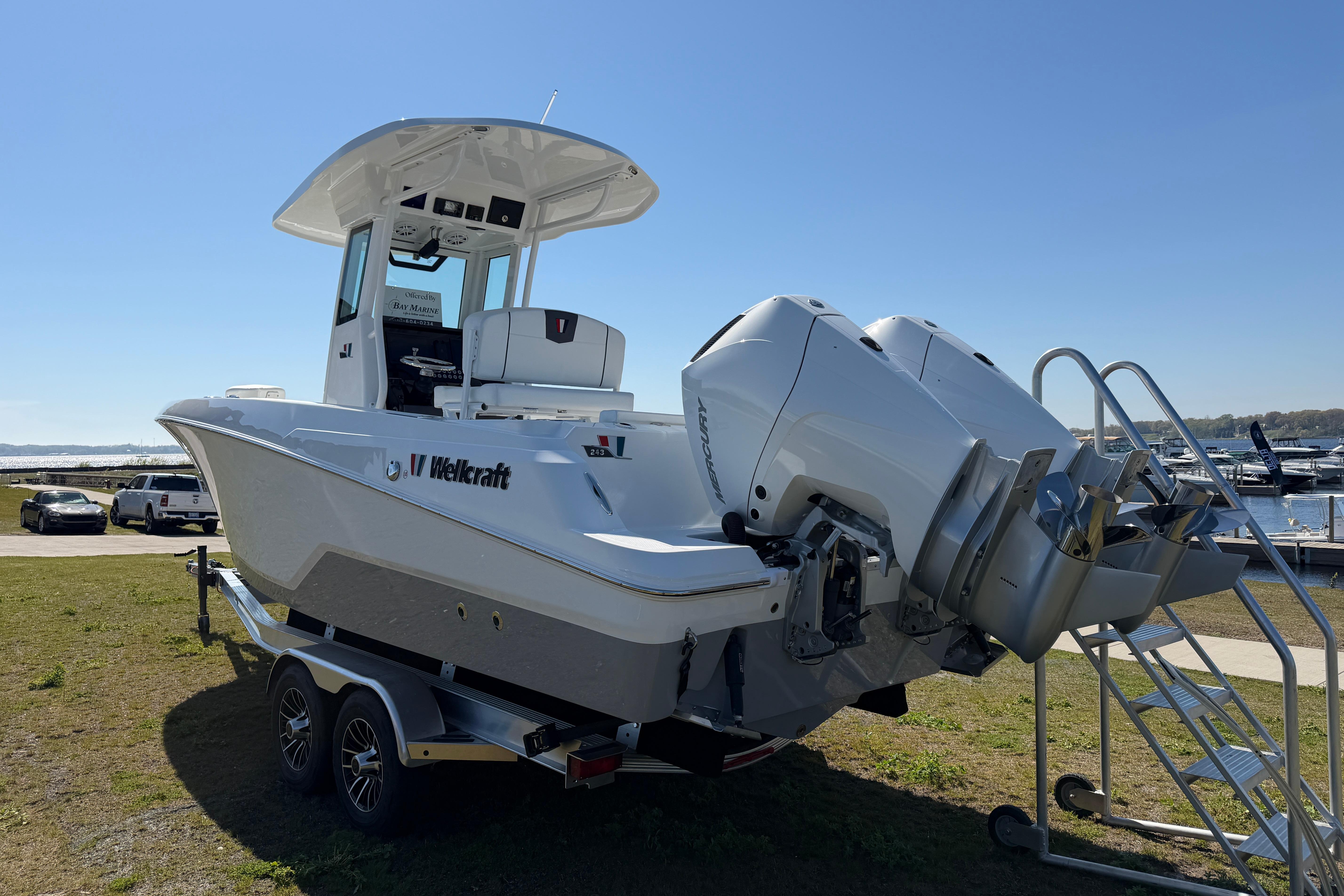 2026 Wellcraft 243 Fisherman boat with dual engines on trailer.