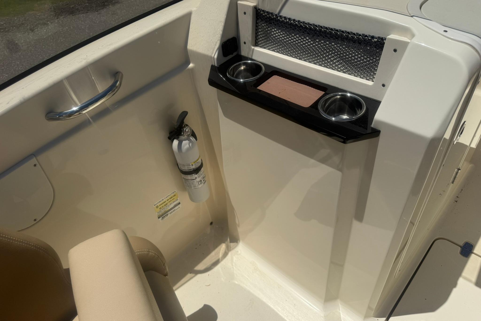 Interior of 2021 Scout 215 Dorado boat with cup holders and fire extinguisher.