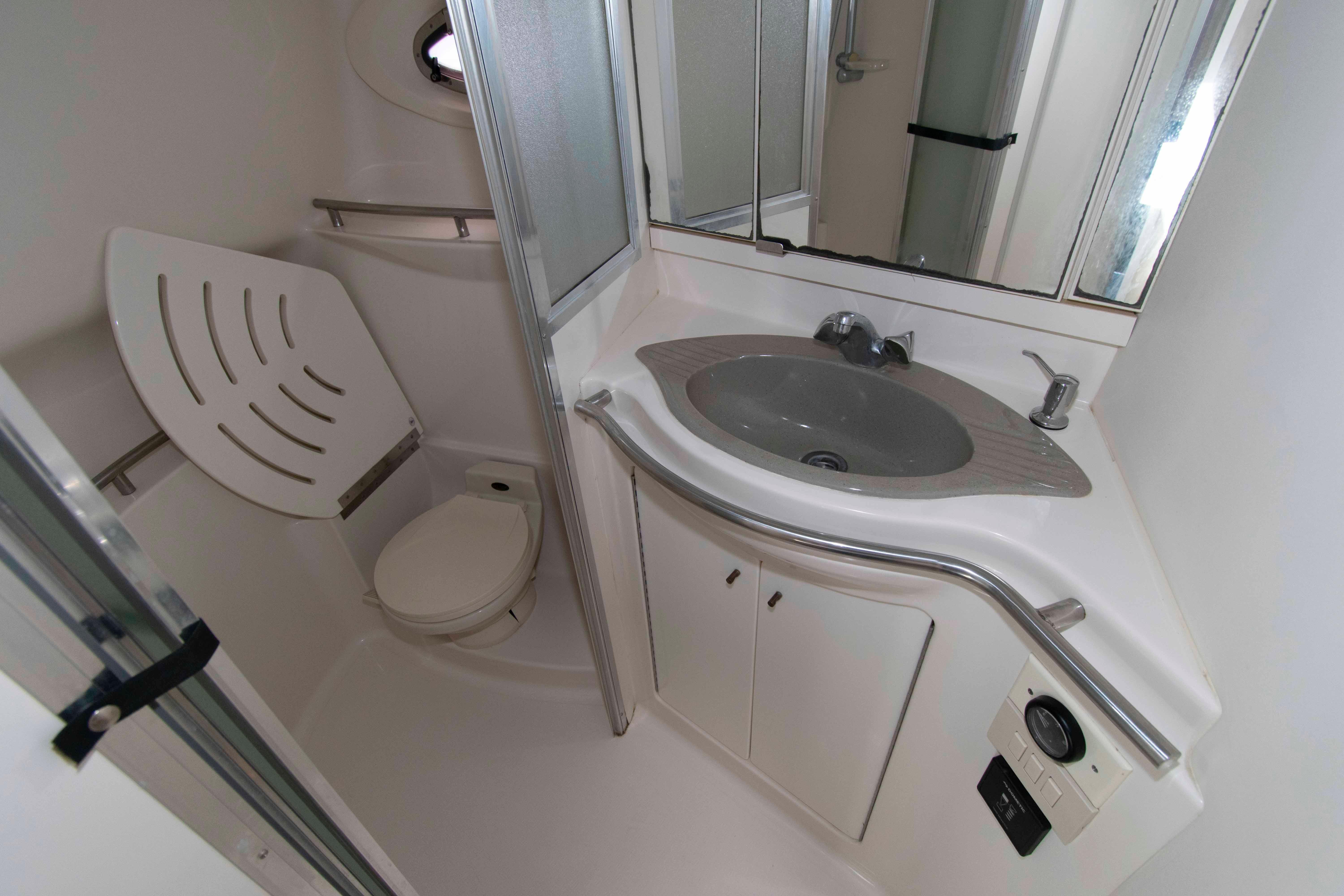 Bathroom interior of 1998 Maxum 4100 SCR yacht with sink and toilet.