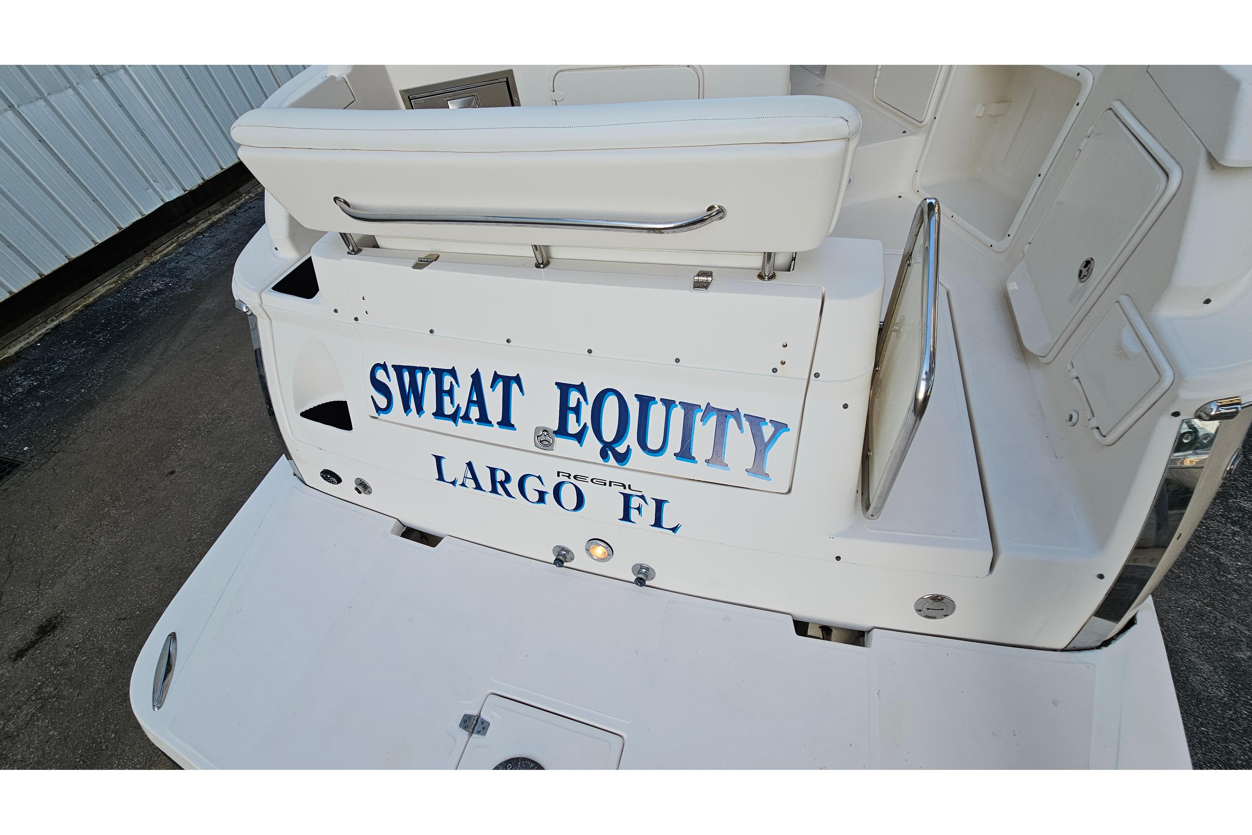 2005 Regal 3060 Window Express boat with "Sweat Equity" name, docked in Largo, FL.
