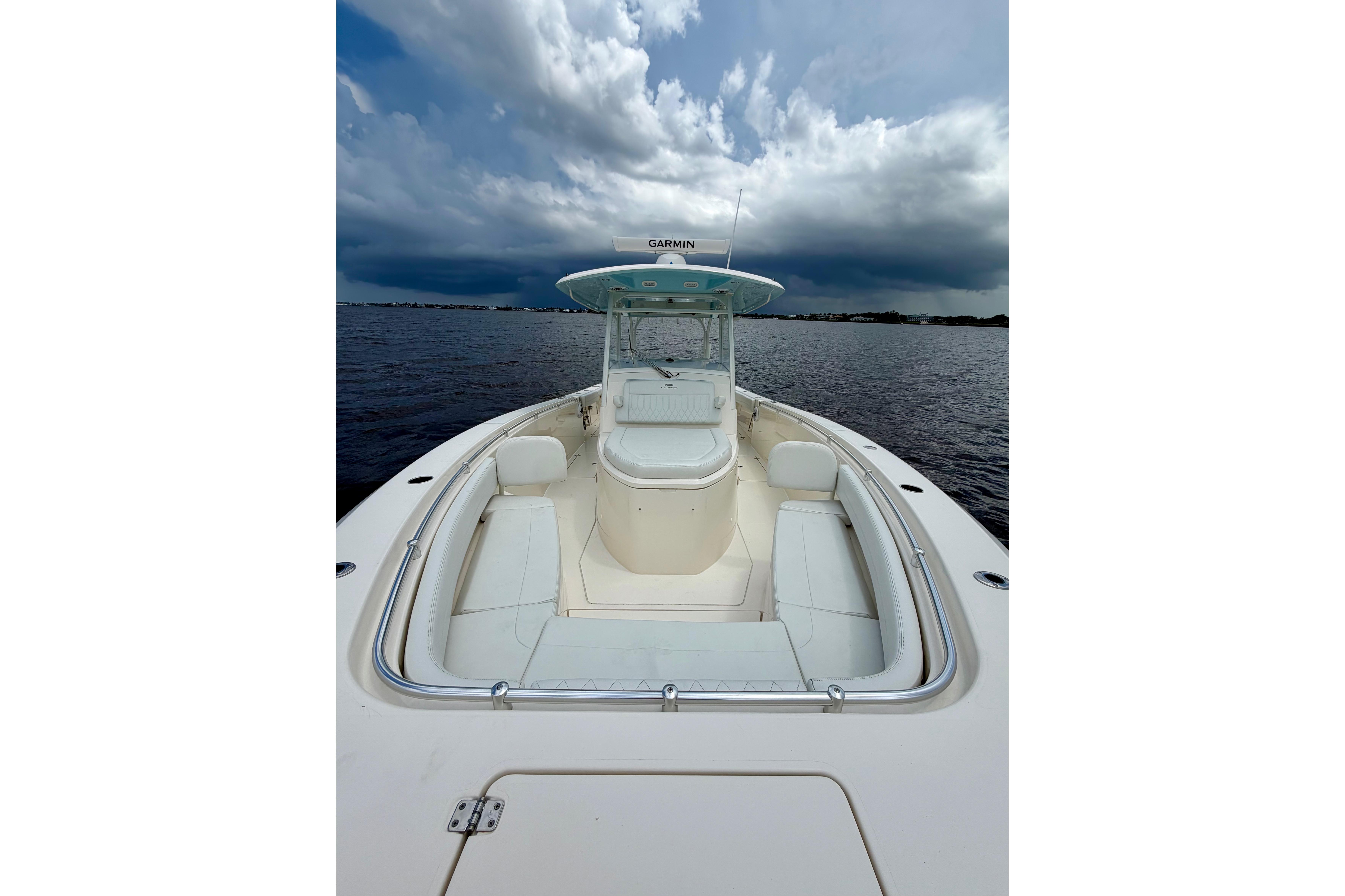 2023 Cobia 350 Center Console boat on water under cloudy sky.