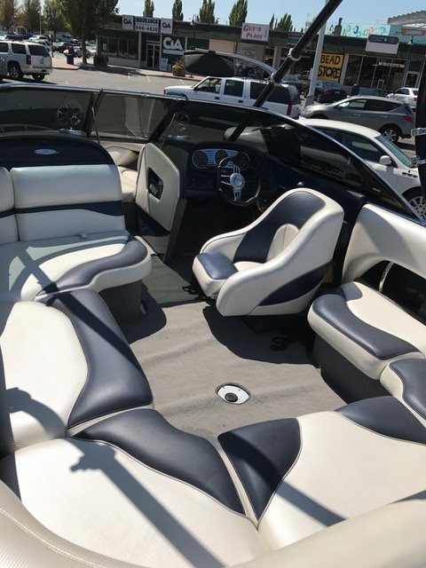 2005 Malibu Open Wakesetter VLX boat interior with white and black seating.