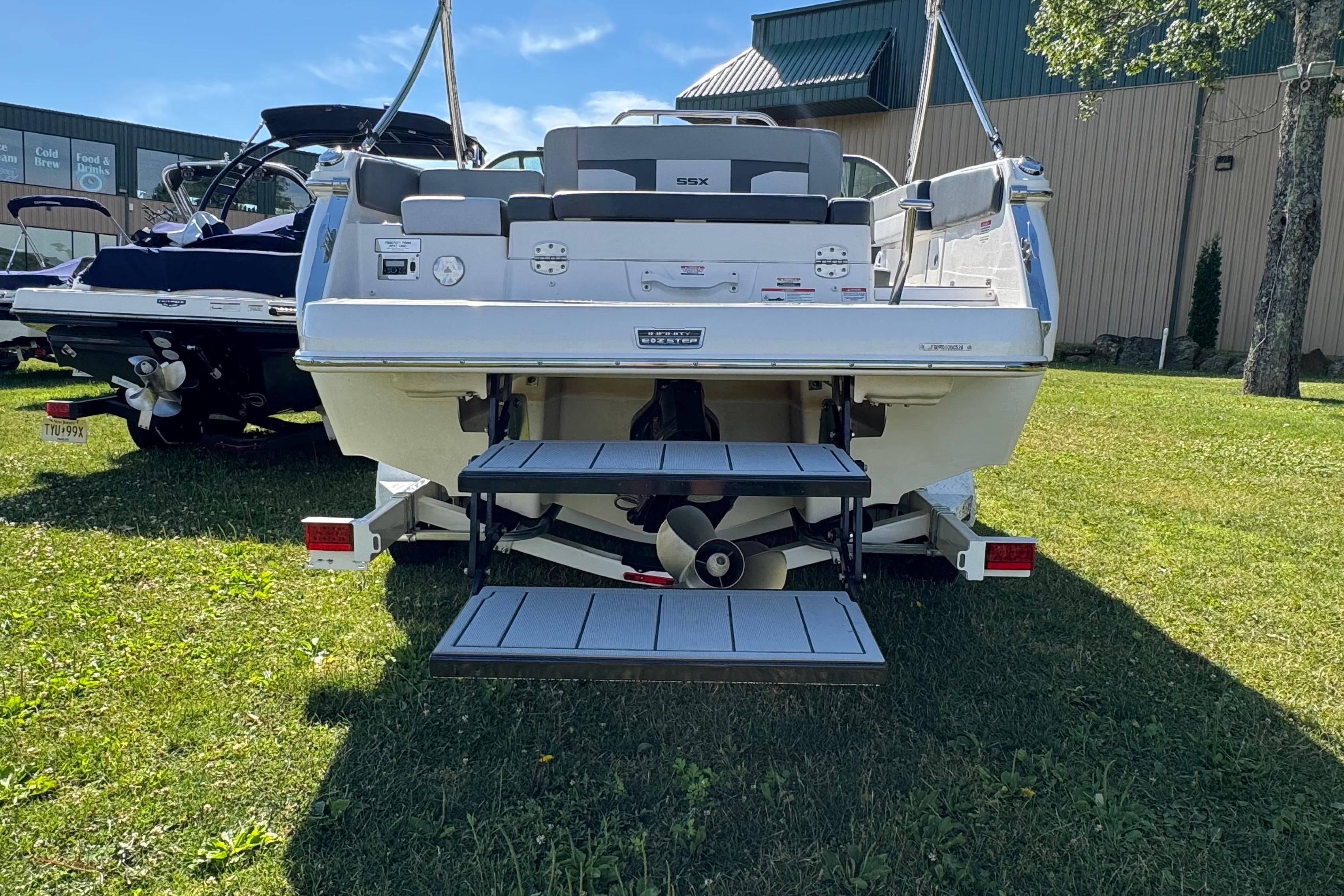 Rear view of 2026 Chaparral SSX 4 boat on grass, showcasing swim platform and propeller.