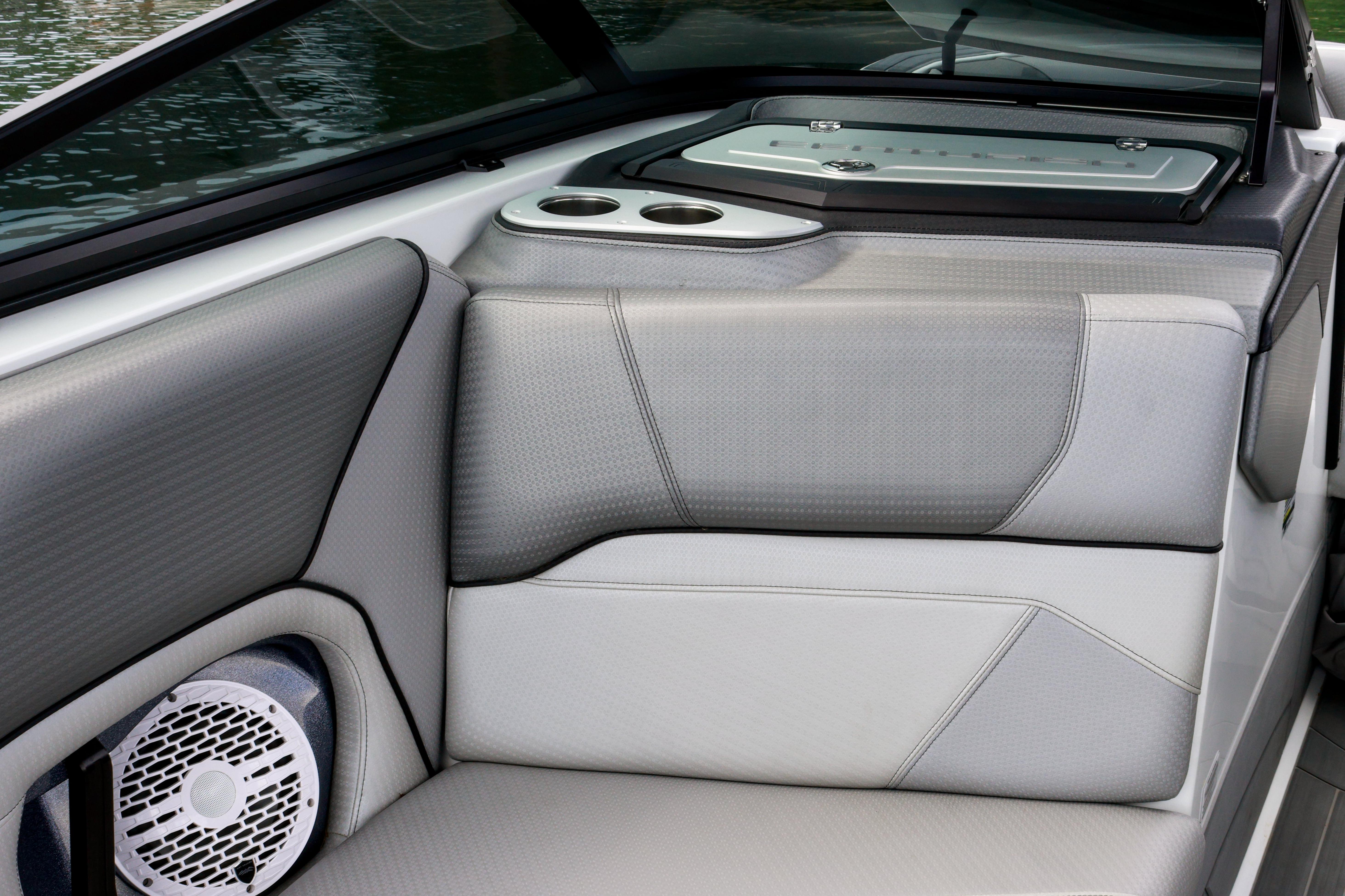 Interior of 2022 Centurion Ri245 boat with sleek seating and speaker system.