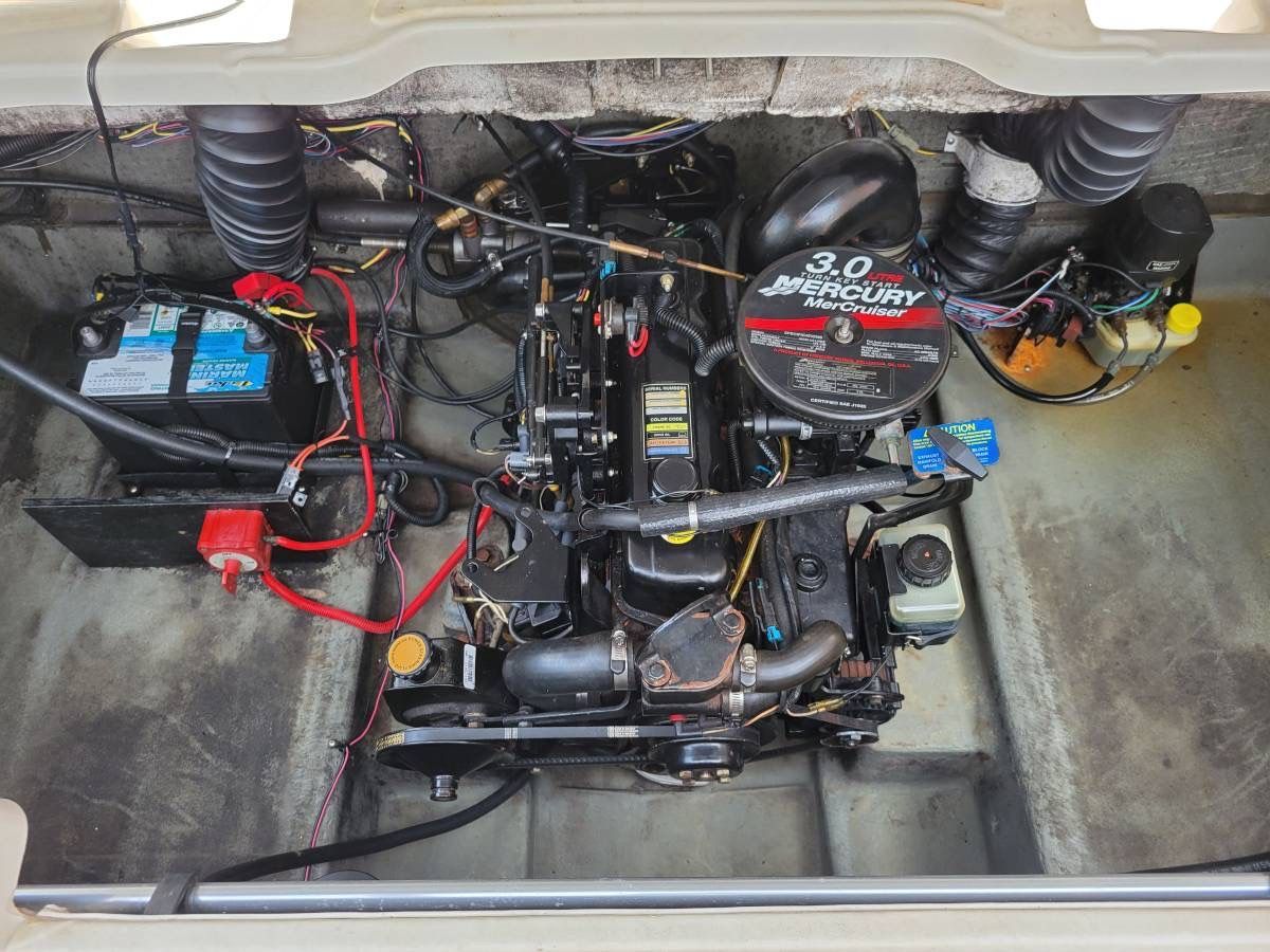 A Mercury 3.0 engine in a Glastron MX-195 boat, surrounded by wires and batteries.