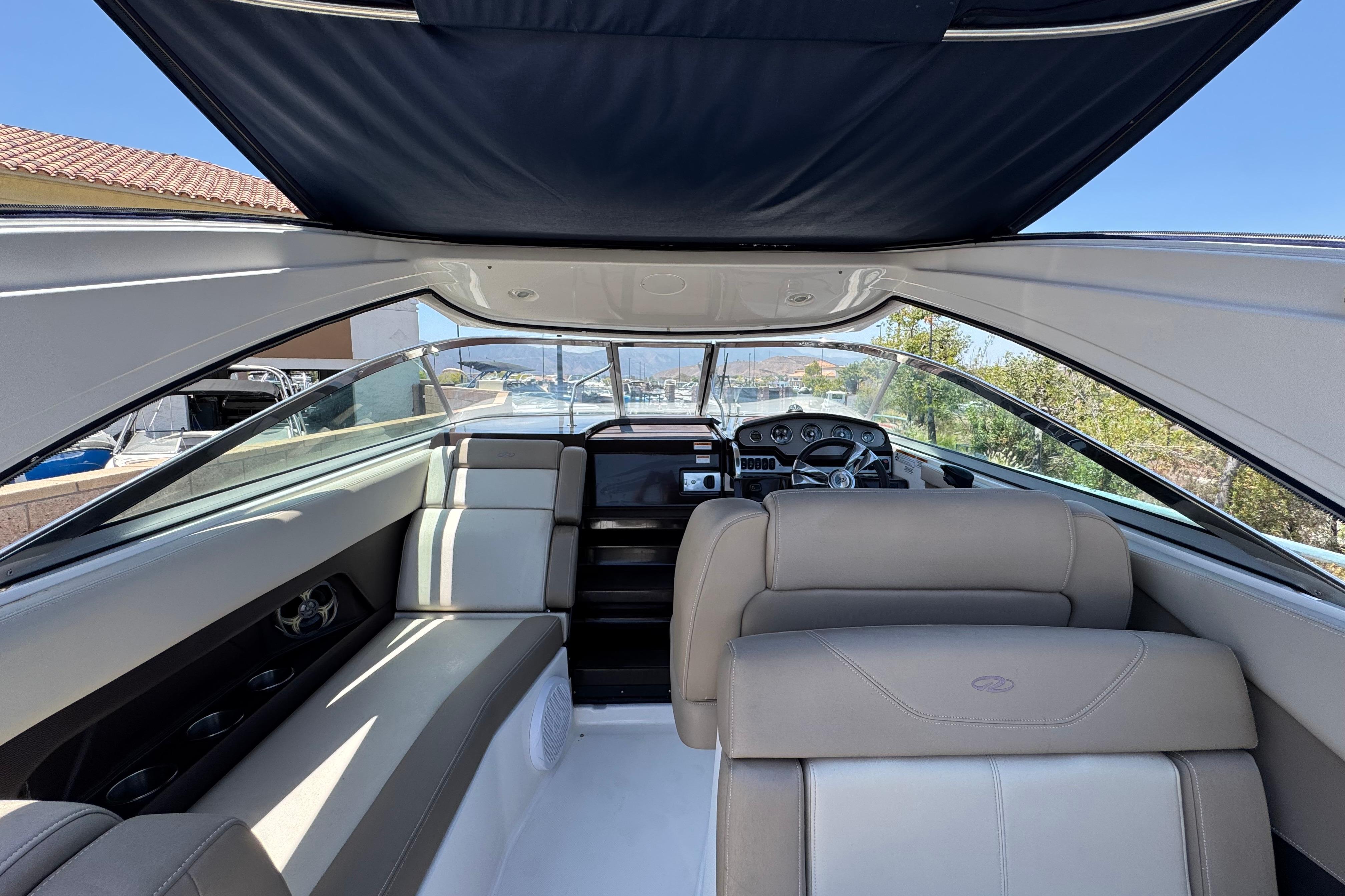 Interior view of a 2013 Regal 28 Express boat with seating and dashboard.