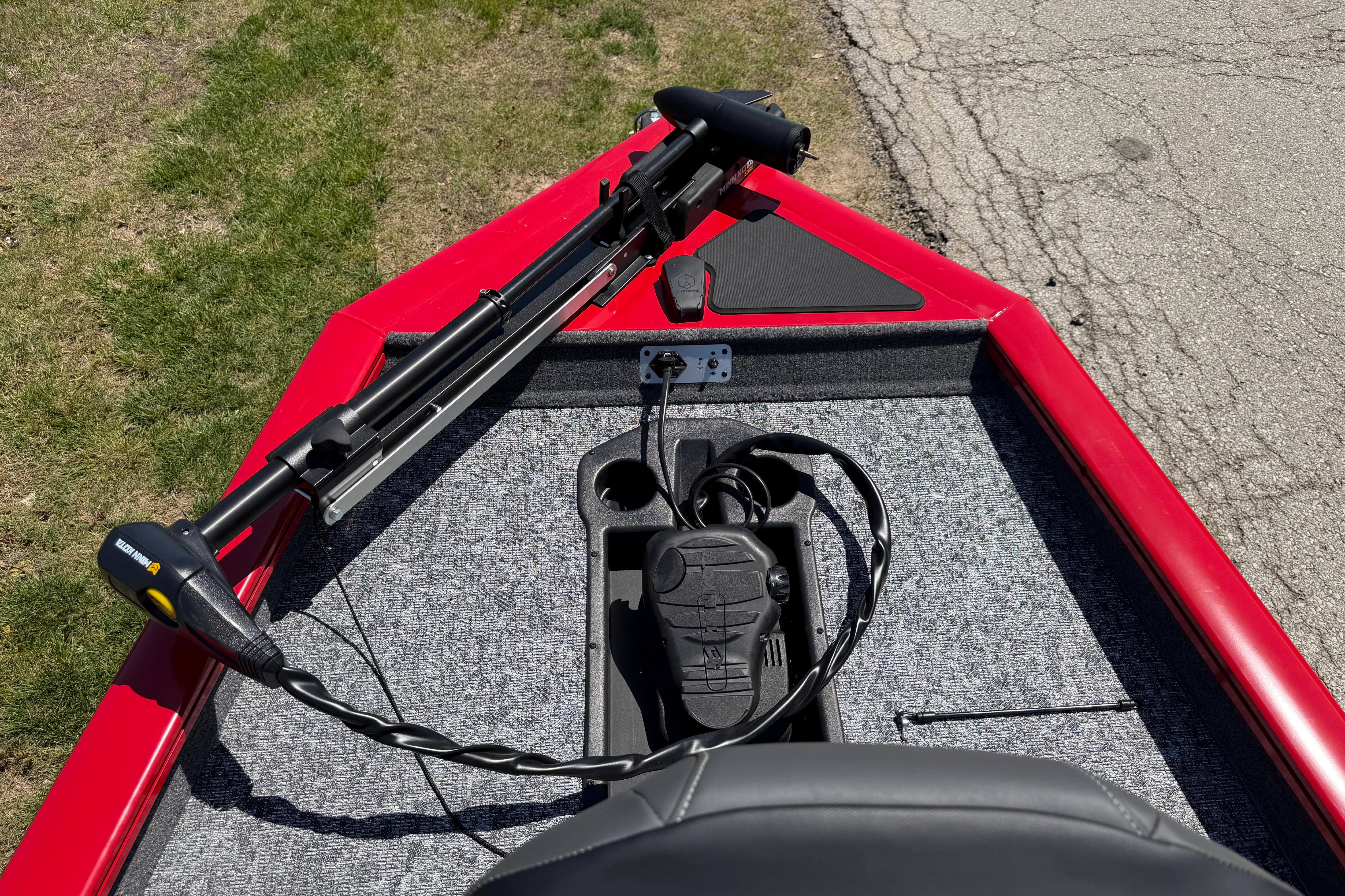 2026 Tracker Pro Team 175 boat with trolling motor on red deck.
