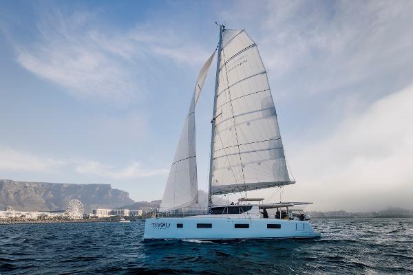 Modern Vision 444 sailboat cruising near a coastal city, 2025 model.