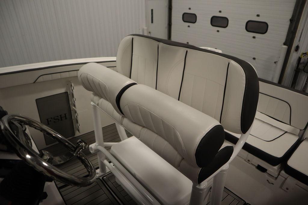 2026 Yamaha Boats 255 FSH Sport E interior with sleek seating and steering wheel.