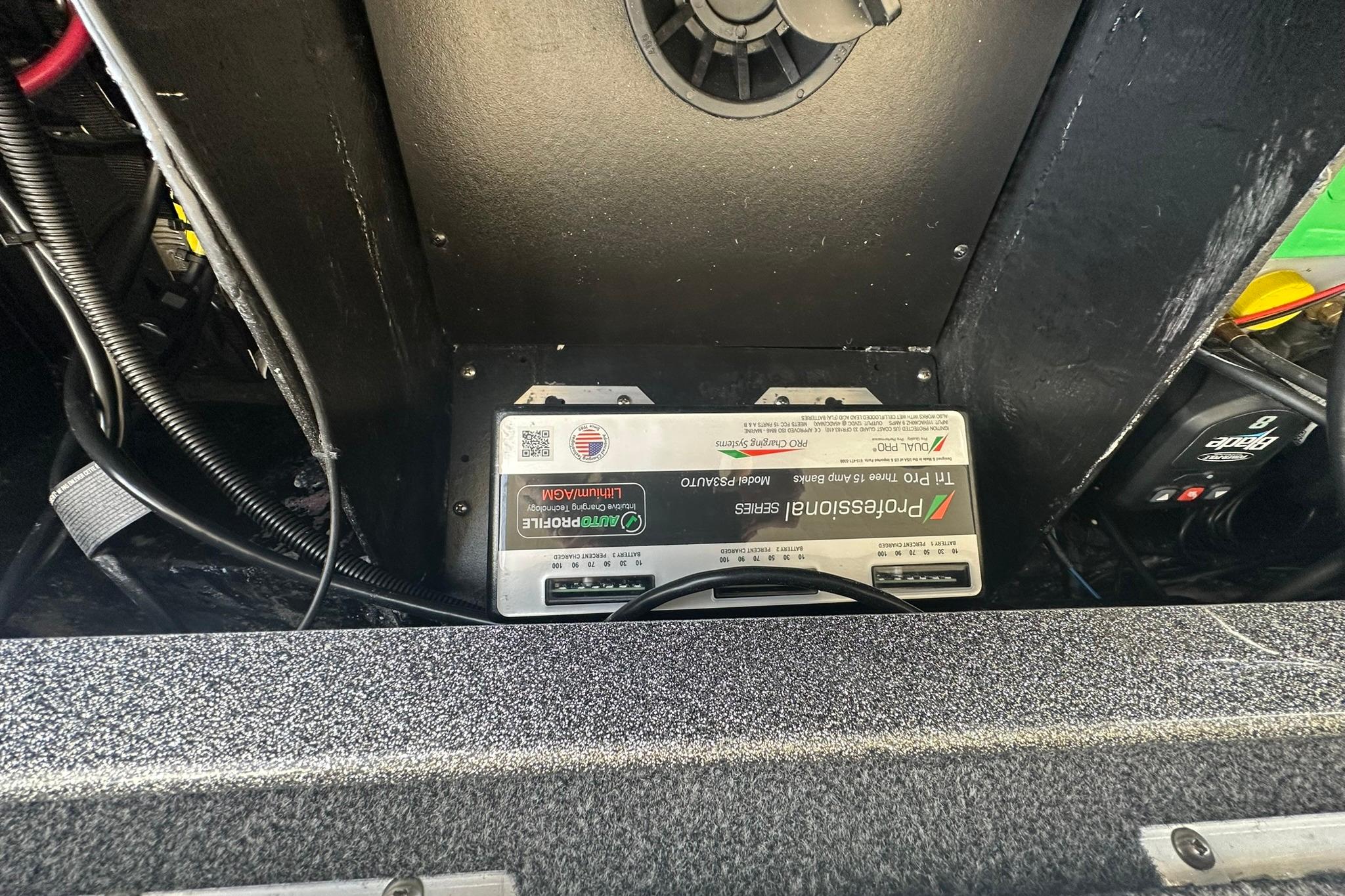 Battery compartment of 2025 Ranger Z185 boat with wiring and charger.