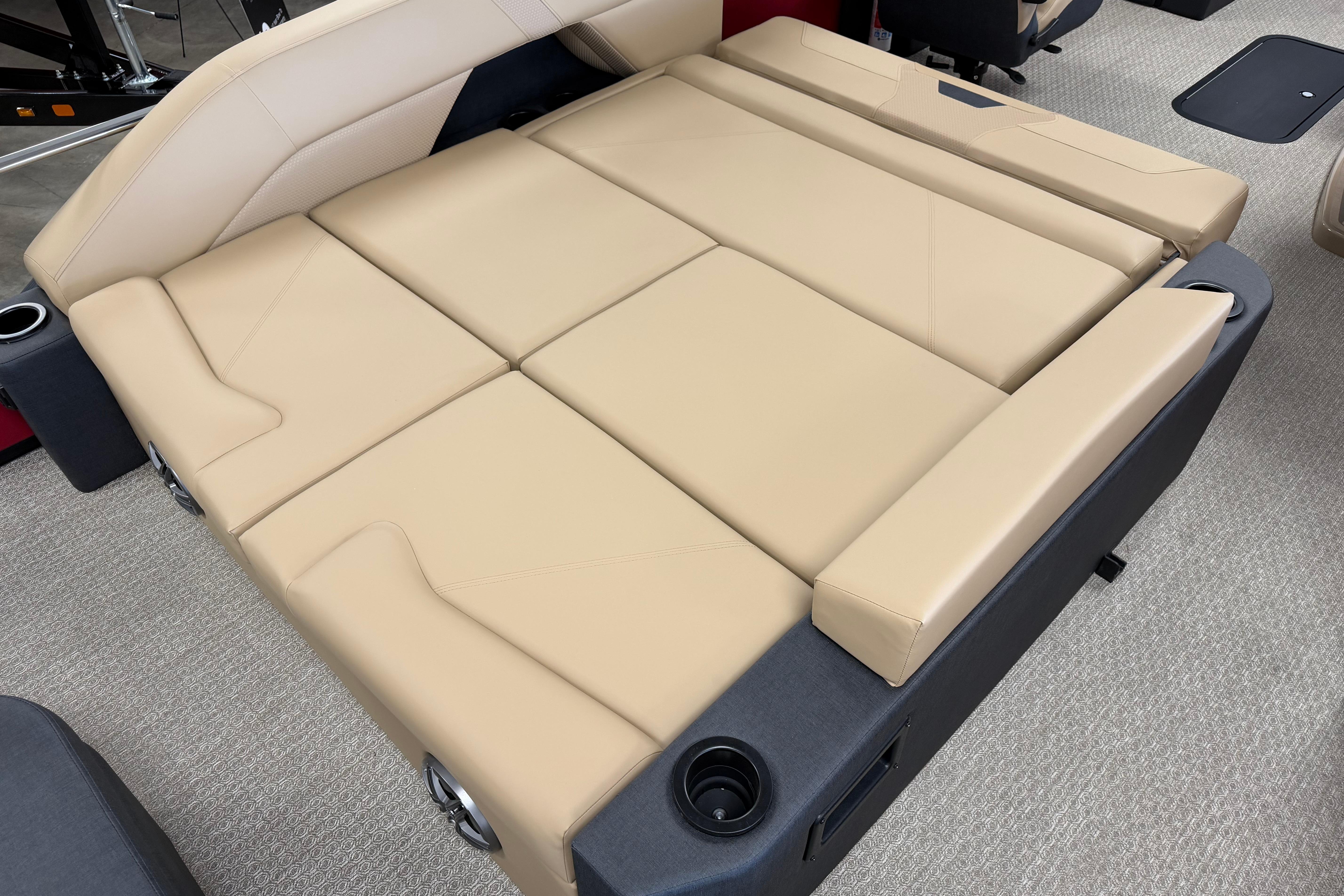 Beige leather seating in 2026 Evotti 523CS boat interior, featuring cup holders.
