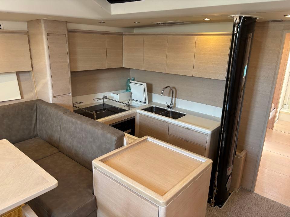 Modern kitchen interior of 2016 Solaris 58 yacht with sleek cabinetry and seating area.