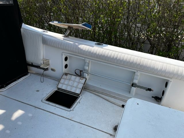 The image shows the deck of a 1998 Sport-Craft 252 Sport Fish boat with storage compartments.