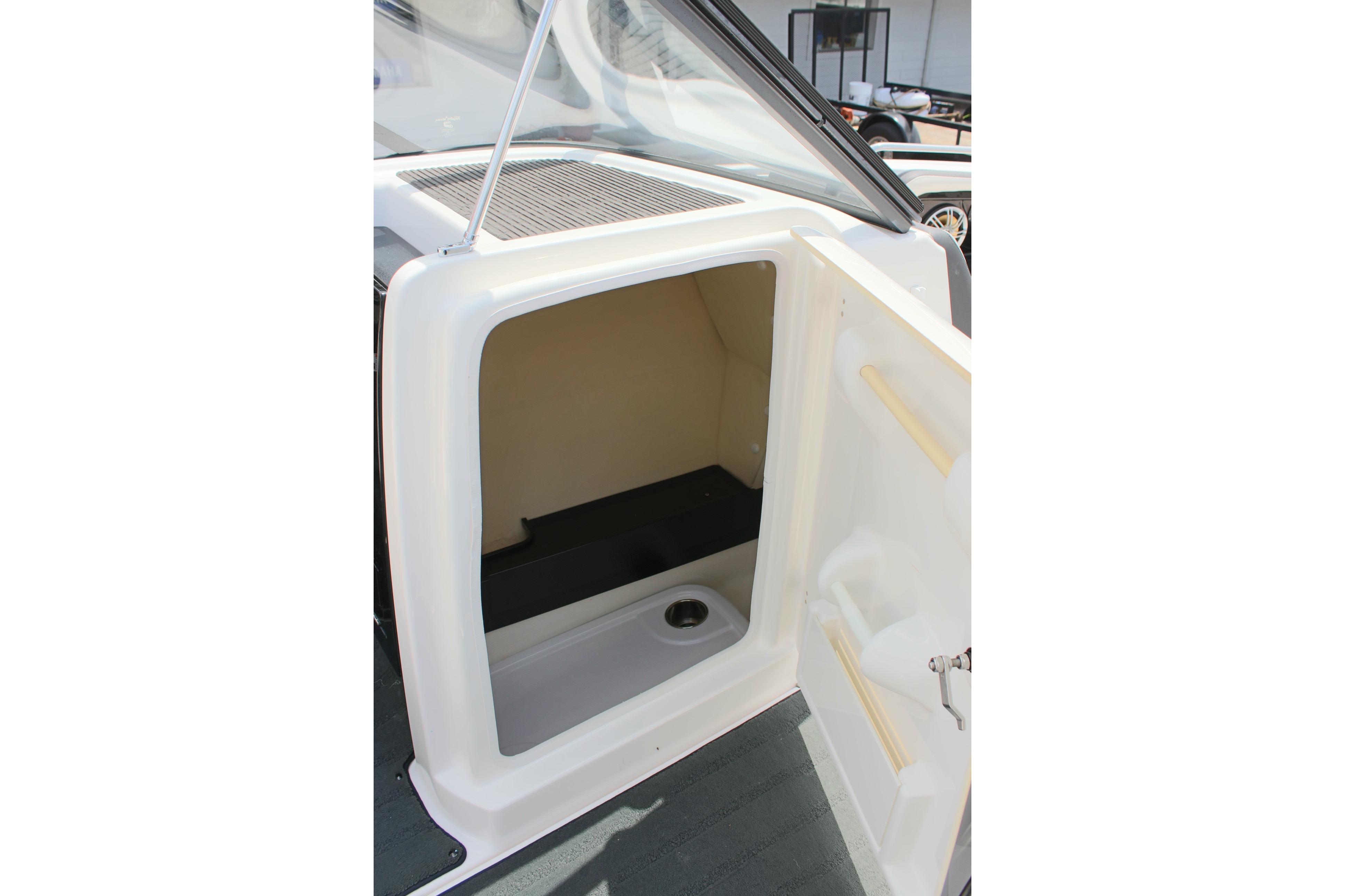 2016 Yamaha Boats 242 Limited S storage compartment with open door.
