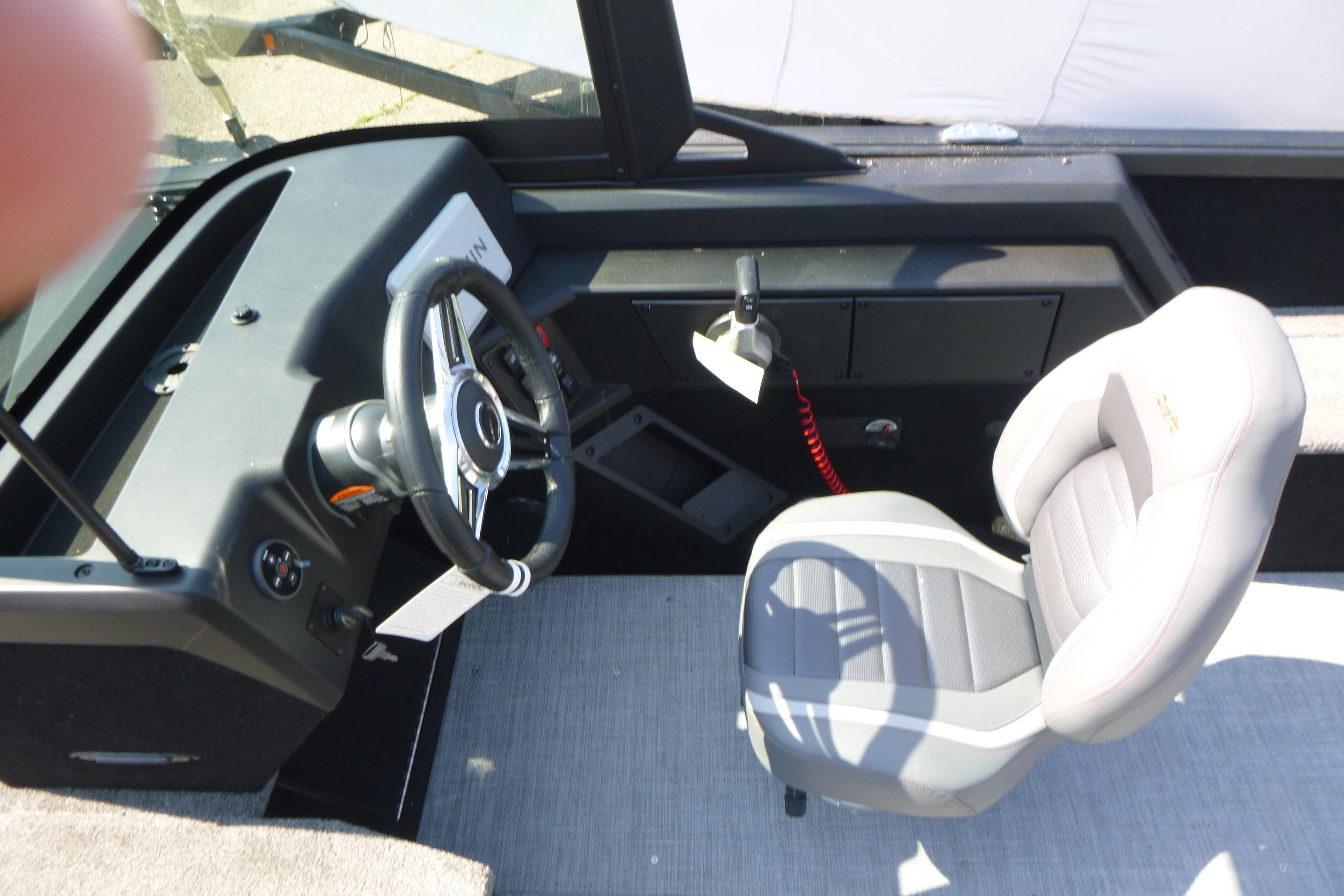2024 Alumacraft Competitor 185X Sport boat interior with steering wheel and captain's chair.