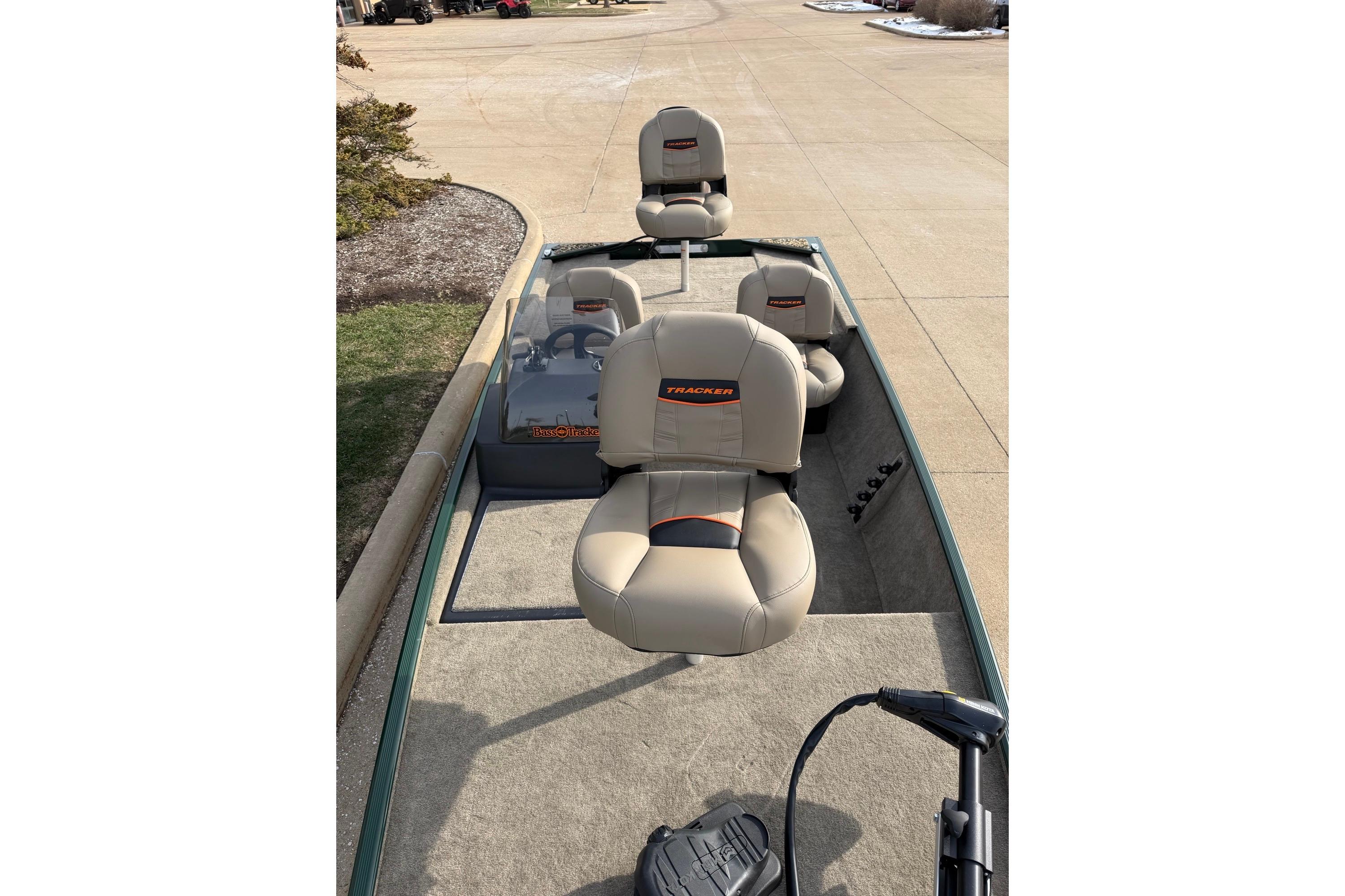 2026 Tracker Bass Tracker Classic Limited boat with beige seats on a driveway.