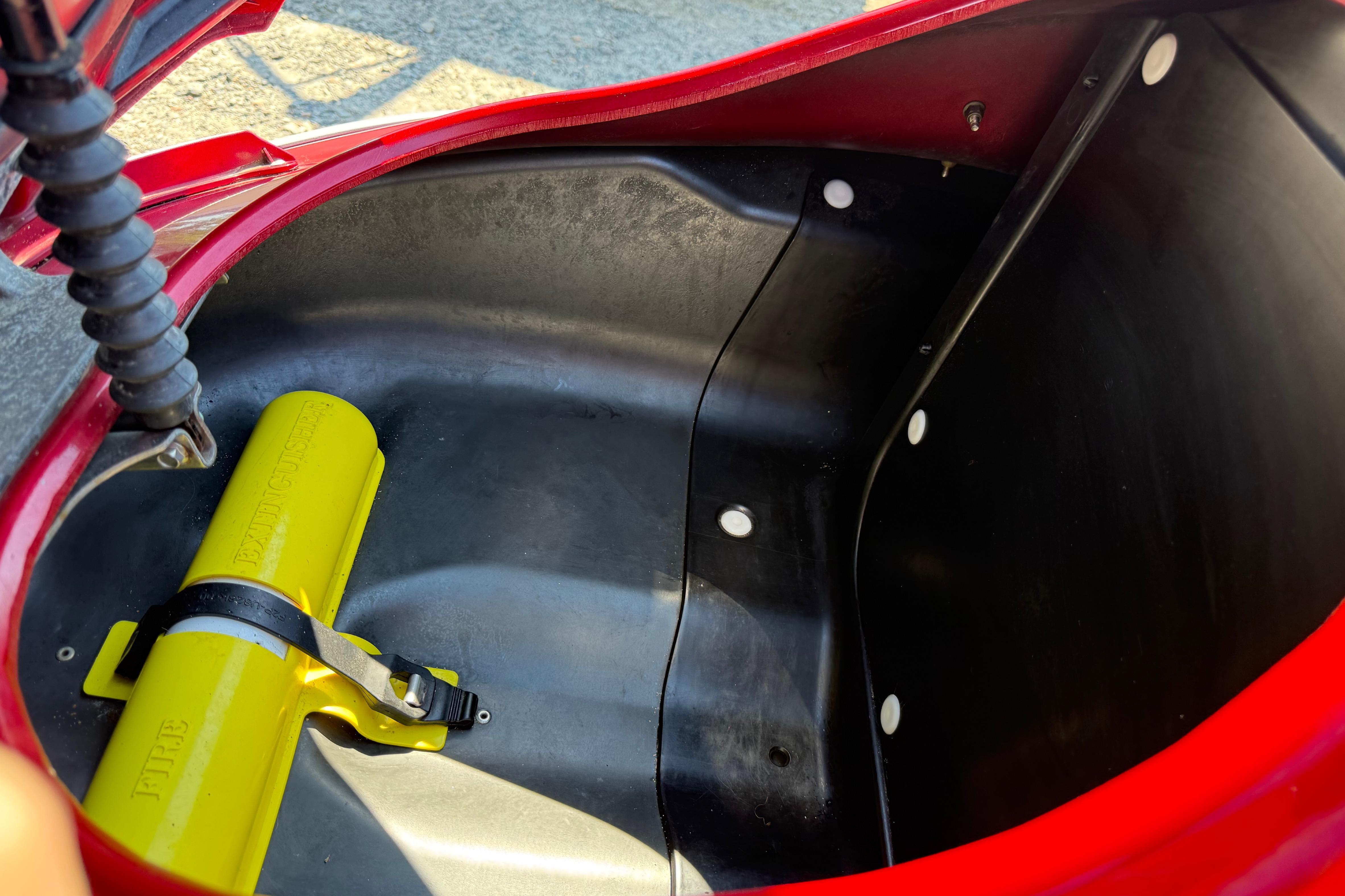 Storage compartment of a 2013 Yamaha WaveRunner FX HO with a yellow fire extinguisher.