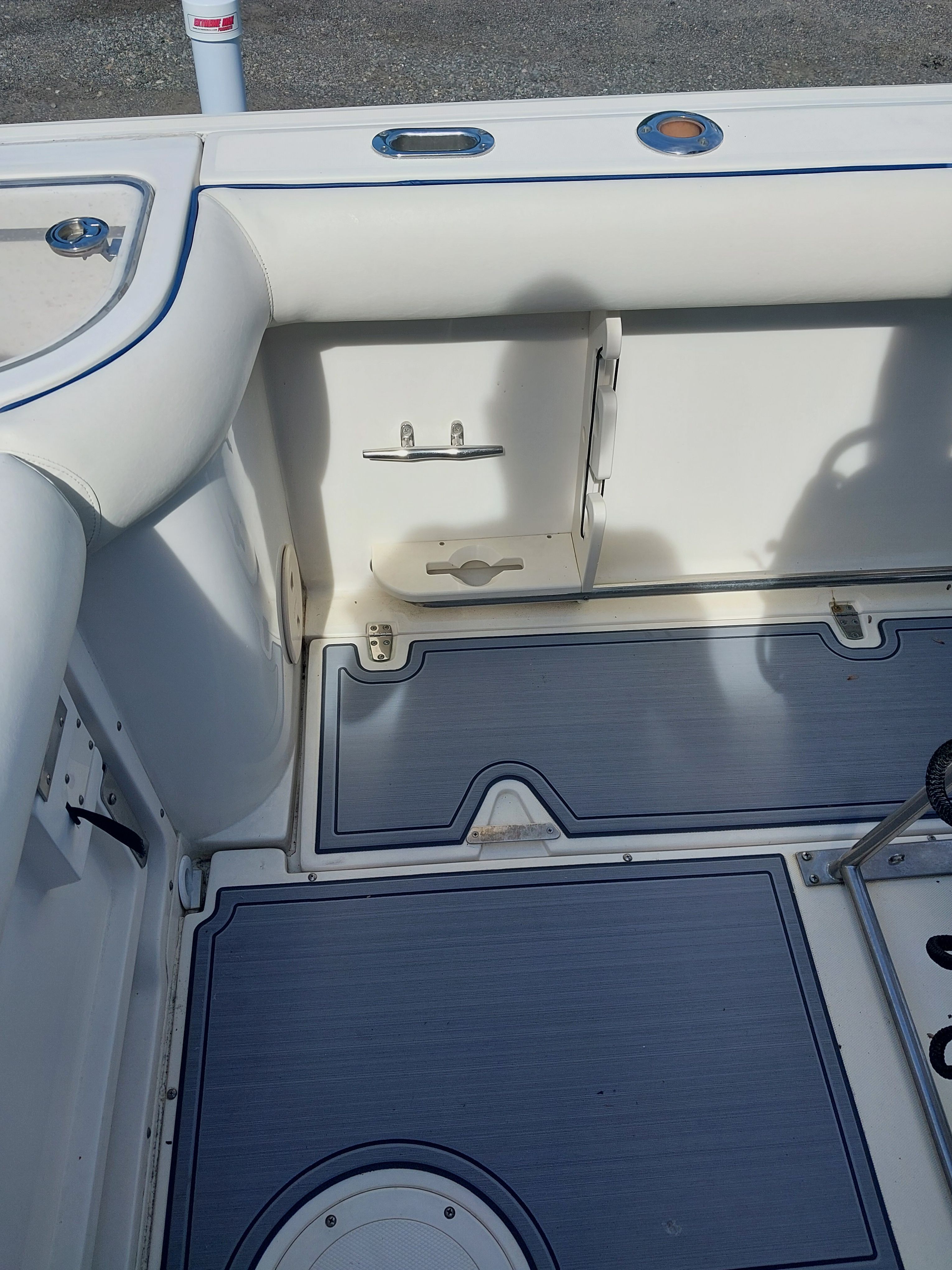 Interior of a 2005 Boston Whaler 240 Outrage with blue accents.