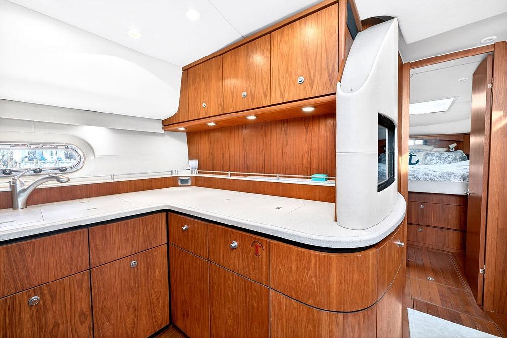 Luxurious 2006 Tiara Yachts 4300 Sovran interior with elegant wood cabinetry and modern amenities.