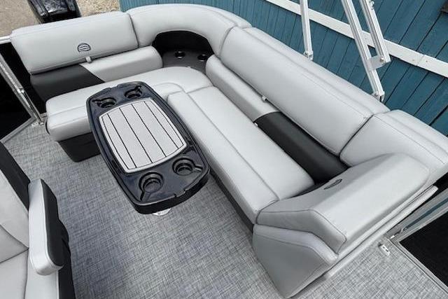 2026 Sun Tracker Party Barge 20 DLX interior with gray seating and table.