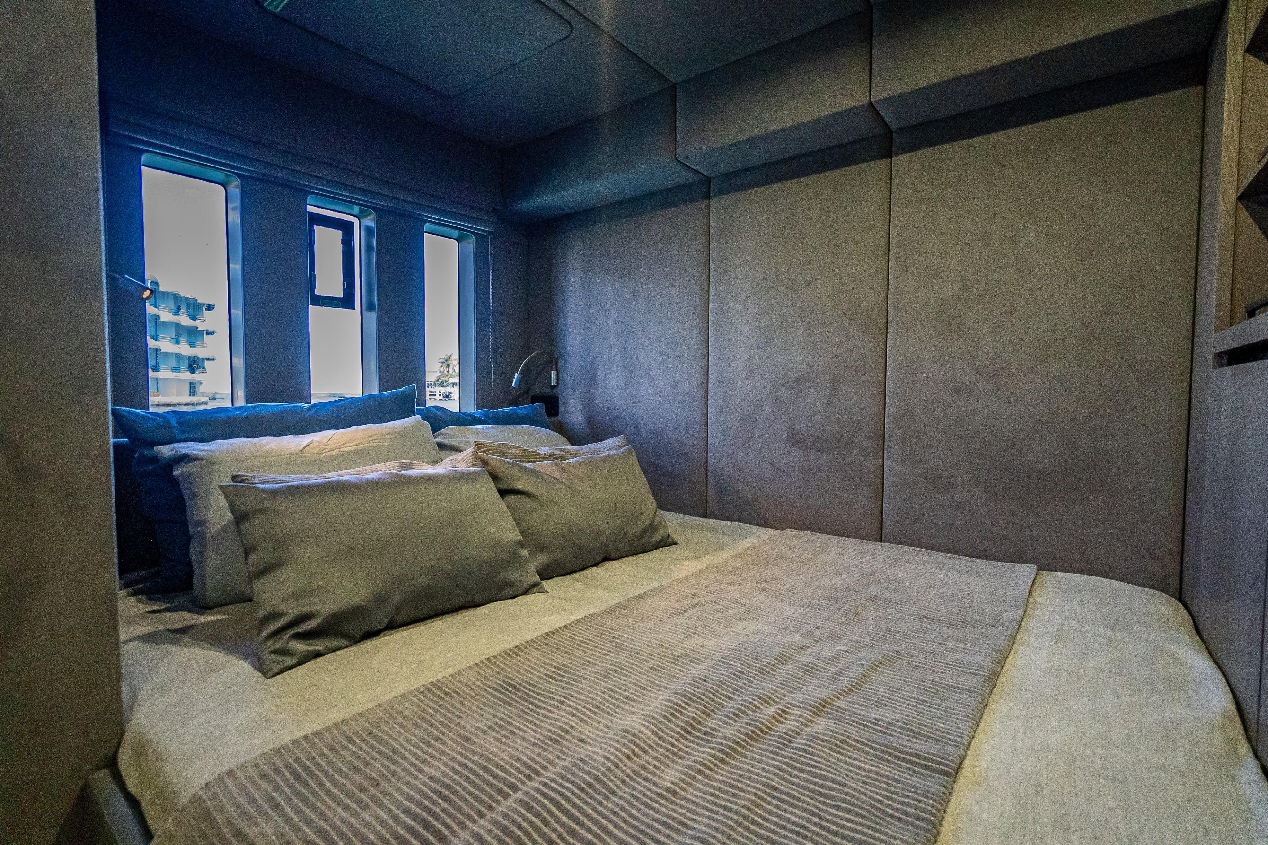 Luxurious bedroom interior of 2026 Sunreef 60 Power yacht with modern design and plush bedding.