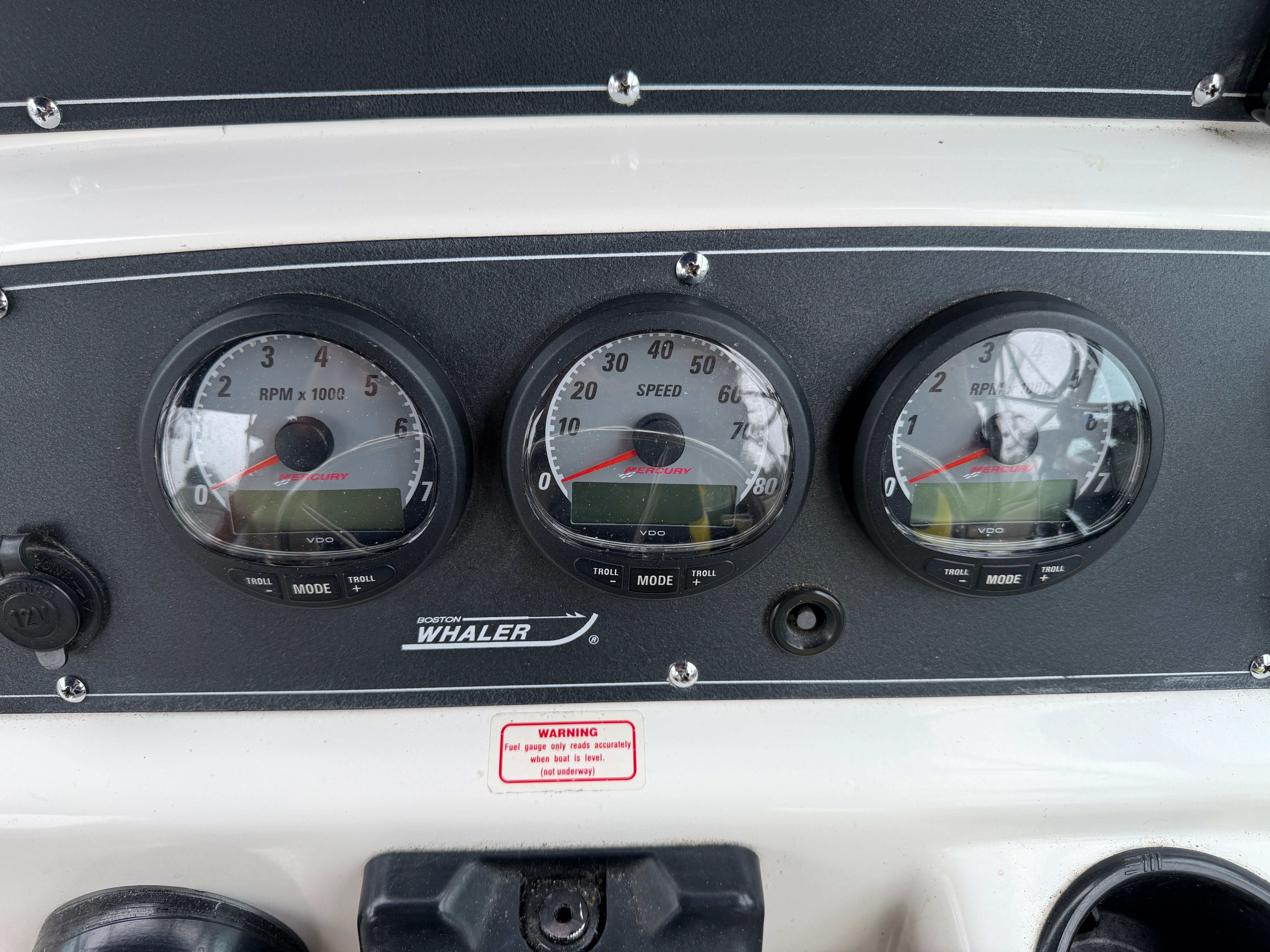 Dashboard with three round gauges and Boston Whaler logo.