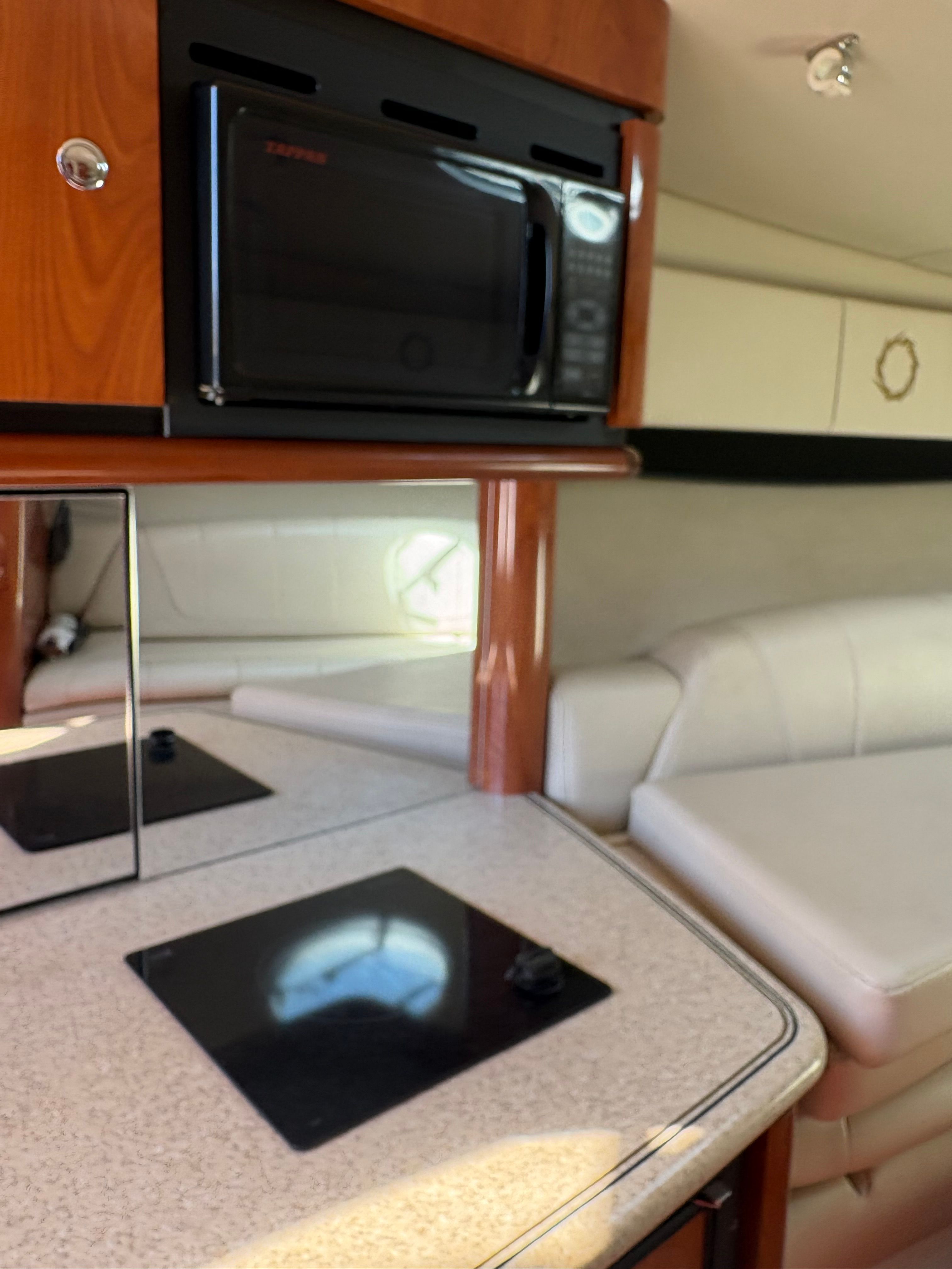 Interior of 2009 Fountain 33 Sportfish Cruiser with kitchenette and sofa.
