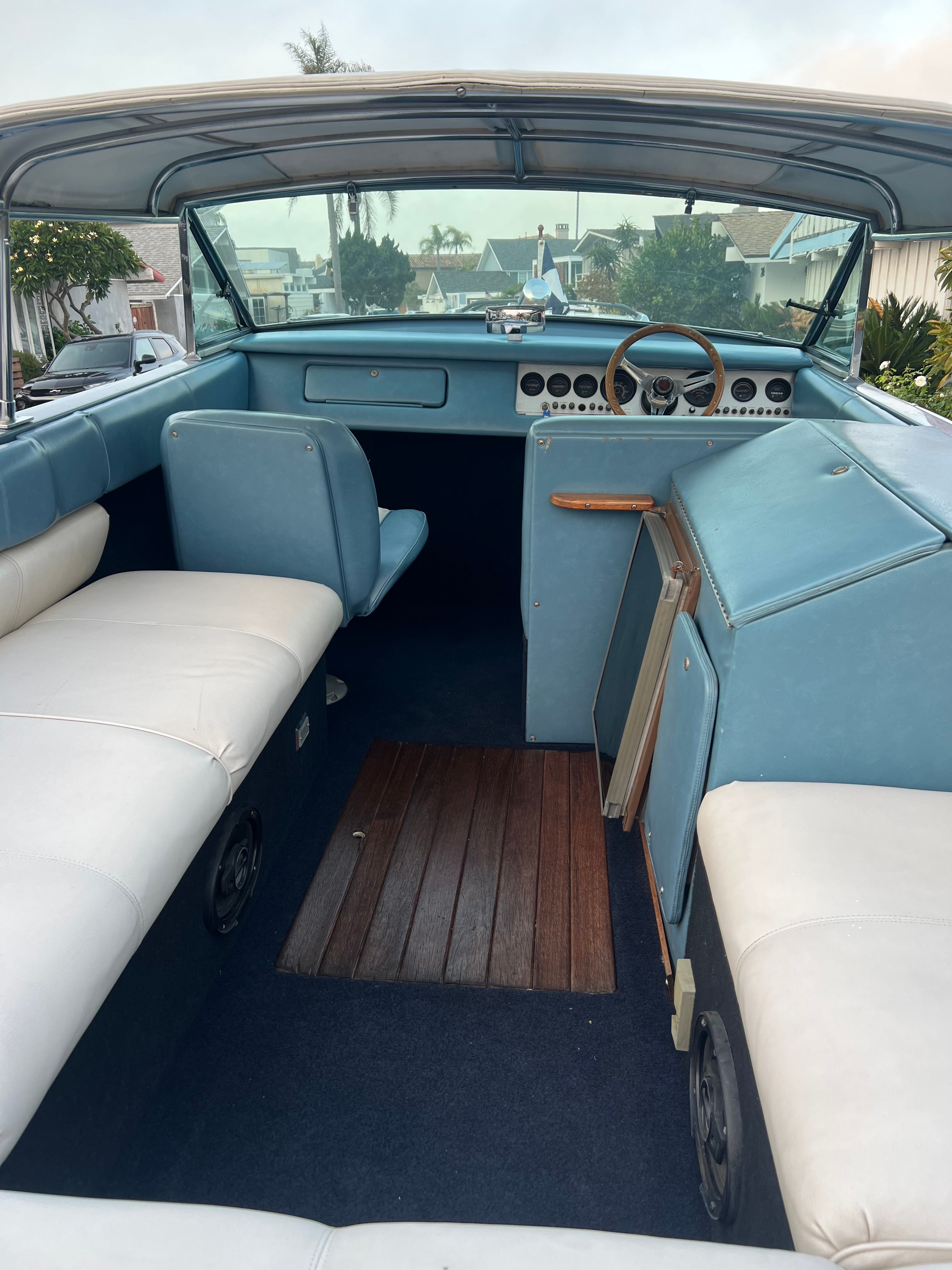 Interior of a 1985 Century Coronado Cardel boat with blue and white seating.