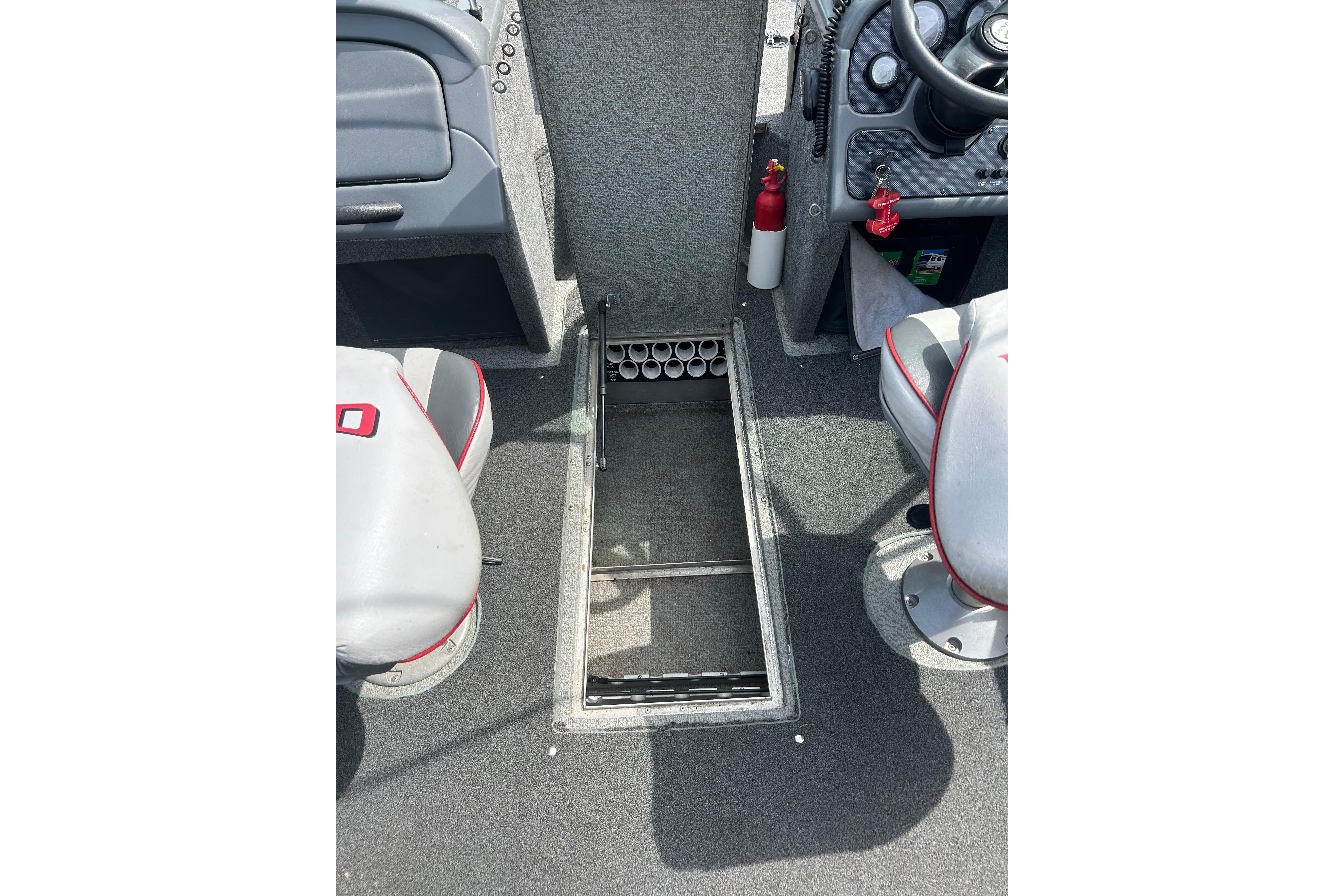 2008 Lund 1850 Fisherman boat interior with storage compartment and seating.
