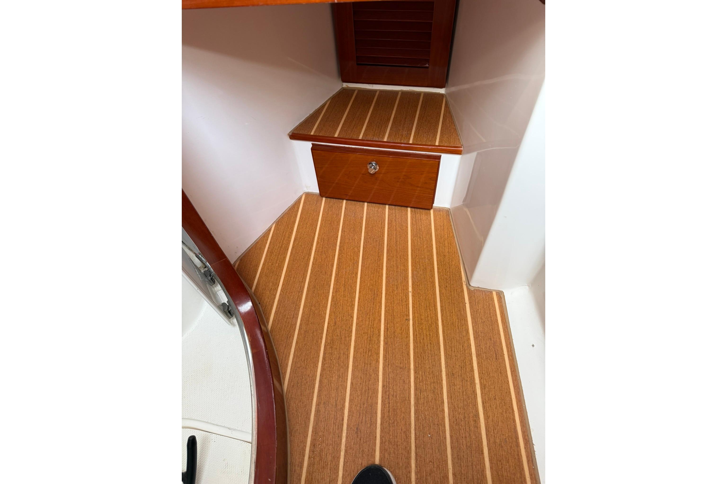 Interior of 2020 SeaPiper 35 boat with wooden flooring and storage drawer.