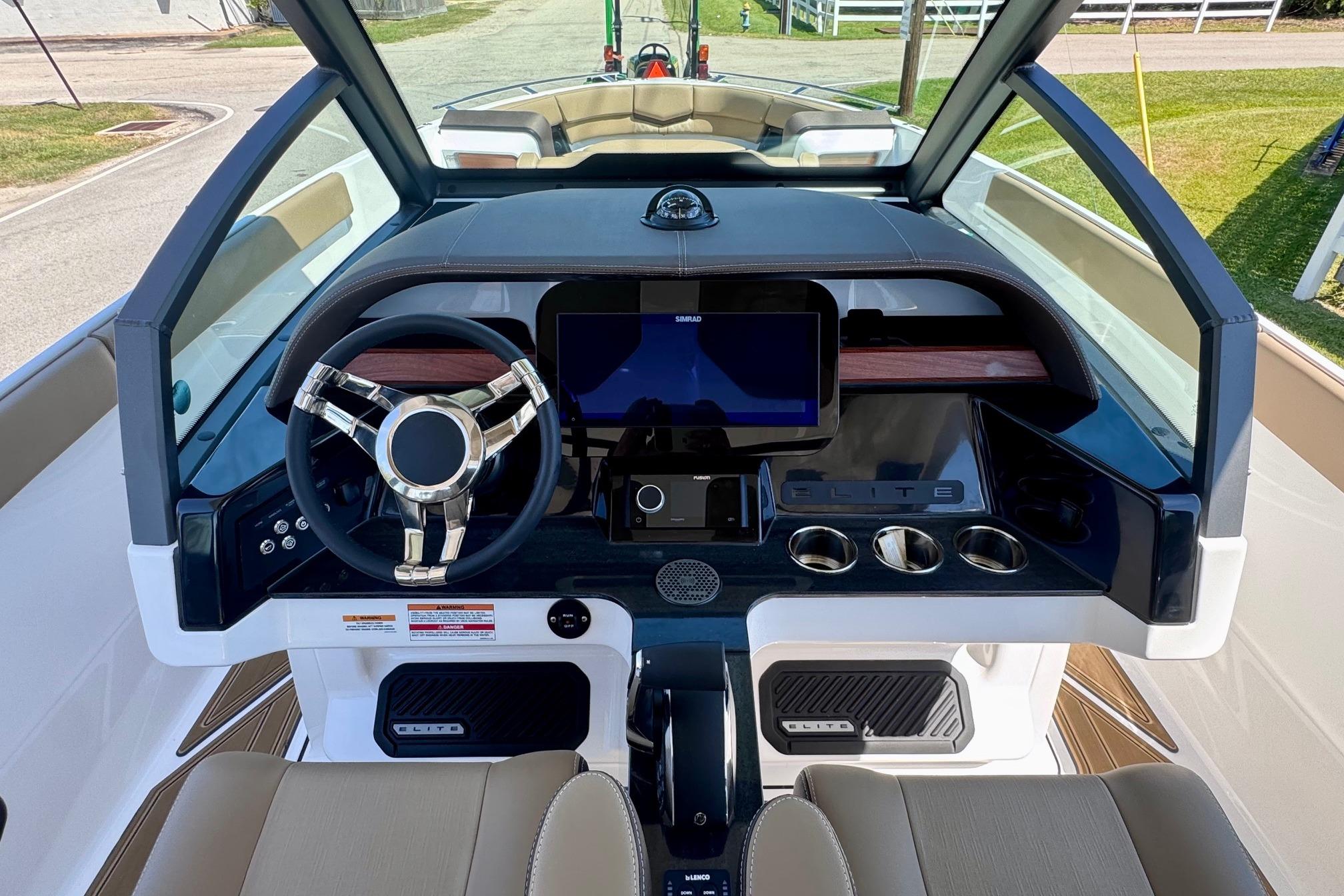 2026 Monterey Elite 27 OB boat dashboard with modern steering wheel and digital display.