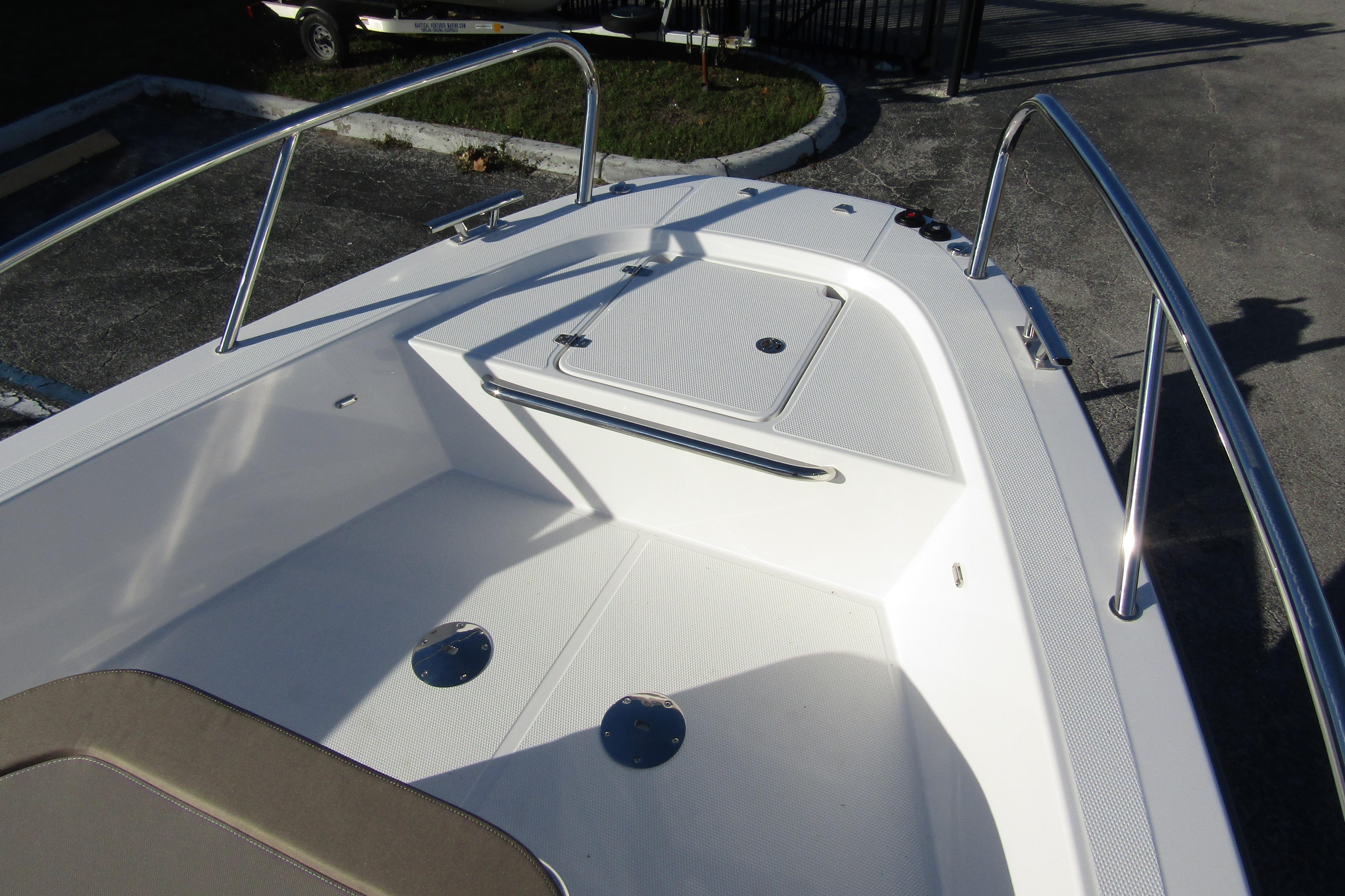 2025 Nimbus Tender 9 boat deck with stainless steel railings and storage compartment.