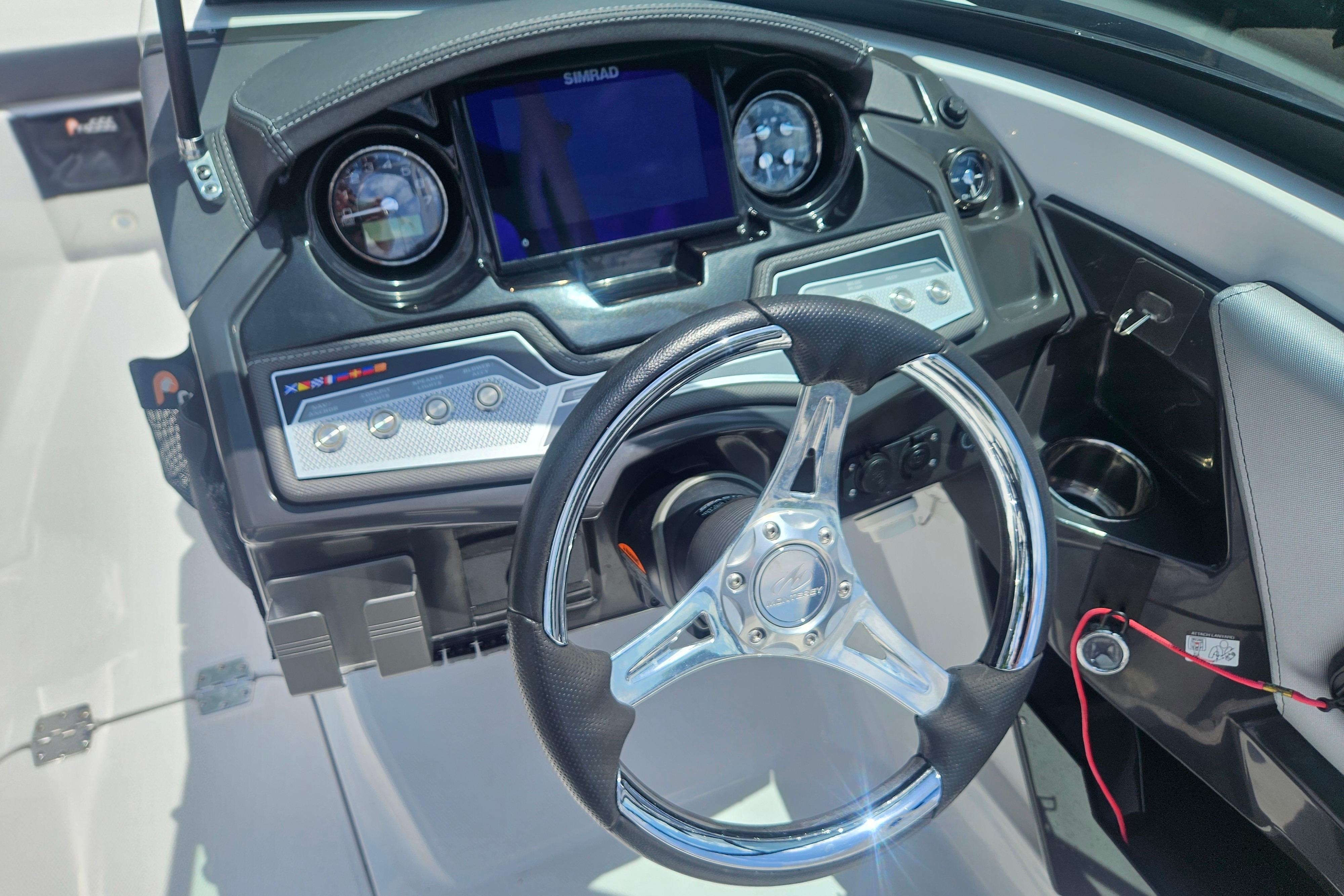 2024 Monterey 215SS Super Sport boat dashboard with steering wheel and control panel.