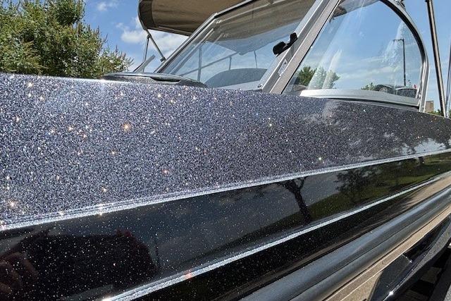2026 Ranger 212LS boat with sparkling metallic finish under clear blue sky.